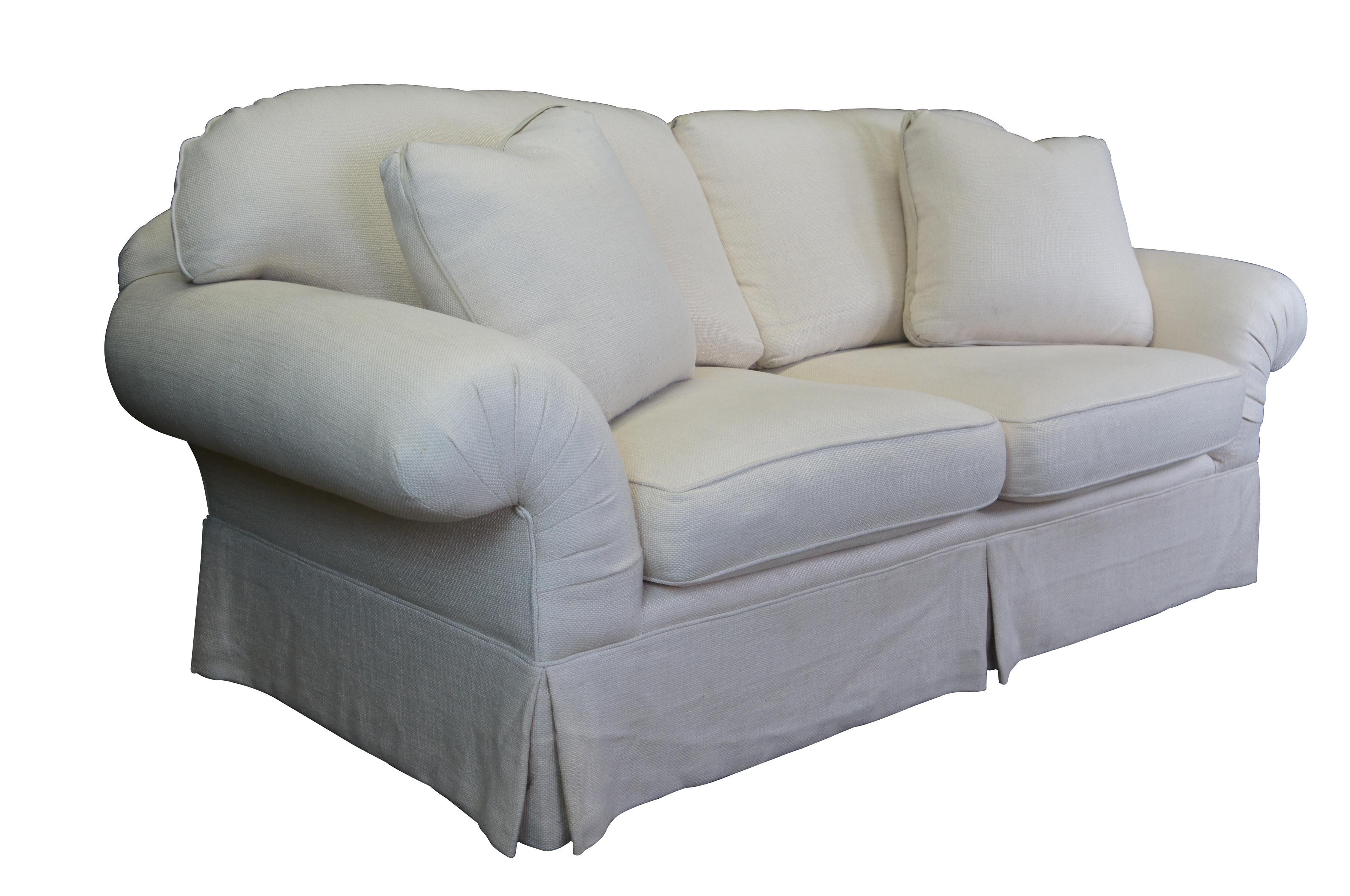 Vintage pair of two contemporary / modern lounge sofas featuring plush overstuffed rolled arm design with off white cotton fabric, skirted base and lumbar pillows.  Attributed to Taylor King.

Dimensions:
42