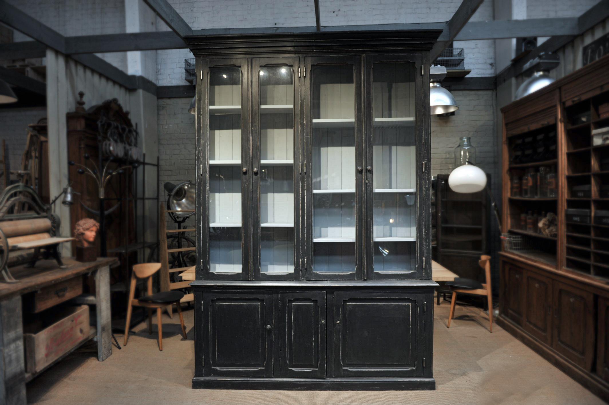French 2 corps bookcase pine cabinet with 4 glass door and 3 doors, circa 1920, comes in 2 parts, bottom part is height 31.5 inches (80 cm). Recent black patina.