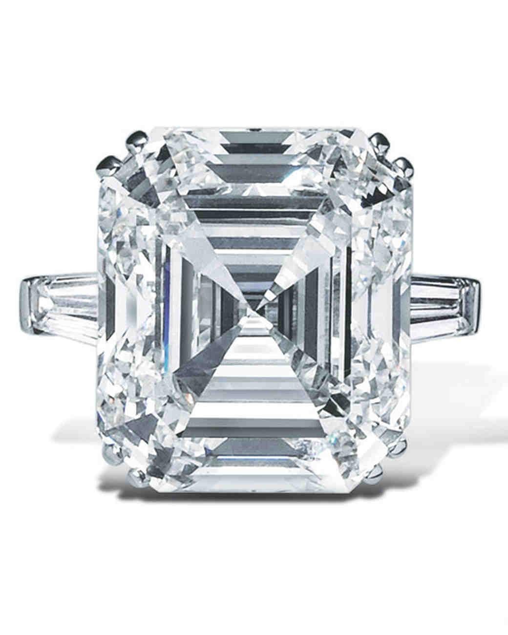 An iconic engagement ring style features an Asscher-cut diamond center stone, given prominence by two tapered baguette side stones, and set on a platinum band. The Classic the three stone setting embodies our collection timeless elegance and