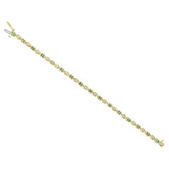 2 CT. Bracciale tennis con smeraldo e diamanti in oro giallo 14k