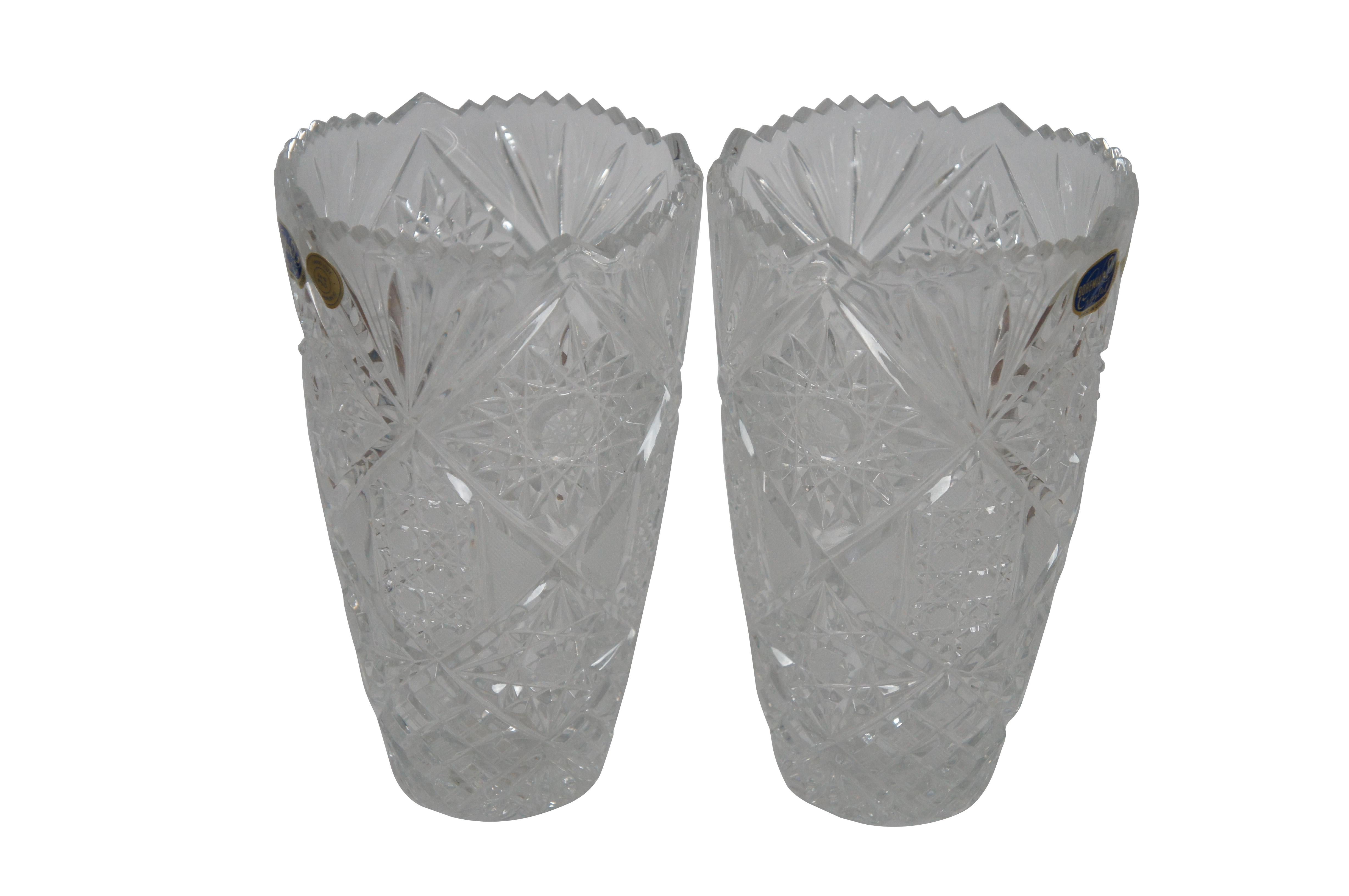 Pair of late 20th century hand cut lead crystal flower vases by Bohemia Crystal in the Queen Lace pattern with tapered base and sawtooth top edge. Made in the Czech Republic.

Dimesions:
5.25