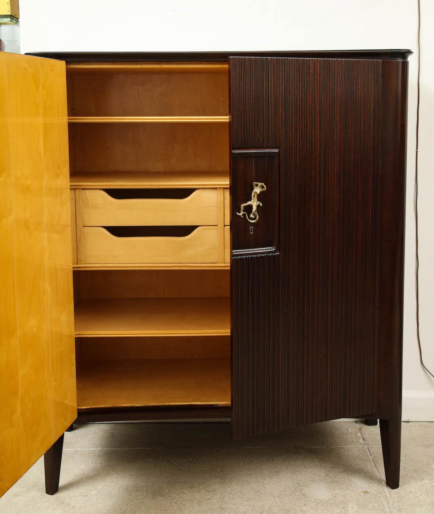 2-Door Cabinet by Osvaldo Borsani & Lucio Fontana for ABV.  Mahogany, bronze, maple, back-painted glass. Dark stained mahogany with fluted door-fronts & inset dark glass top. Interior of bleached wood with adjustable shelving and 4 drawers. Cast