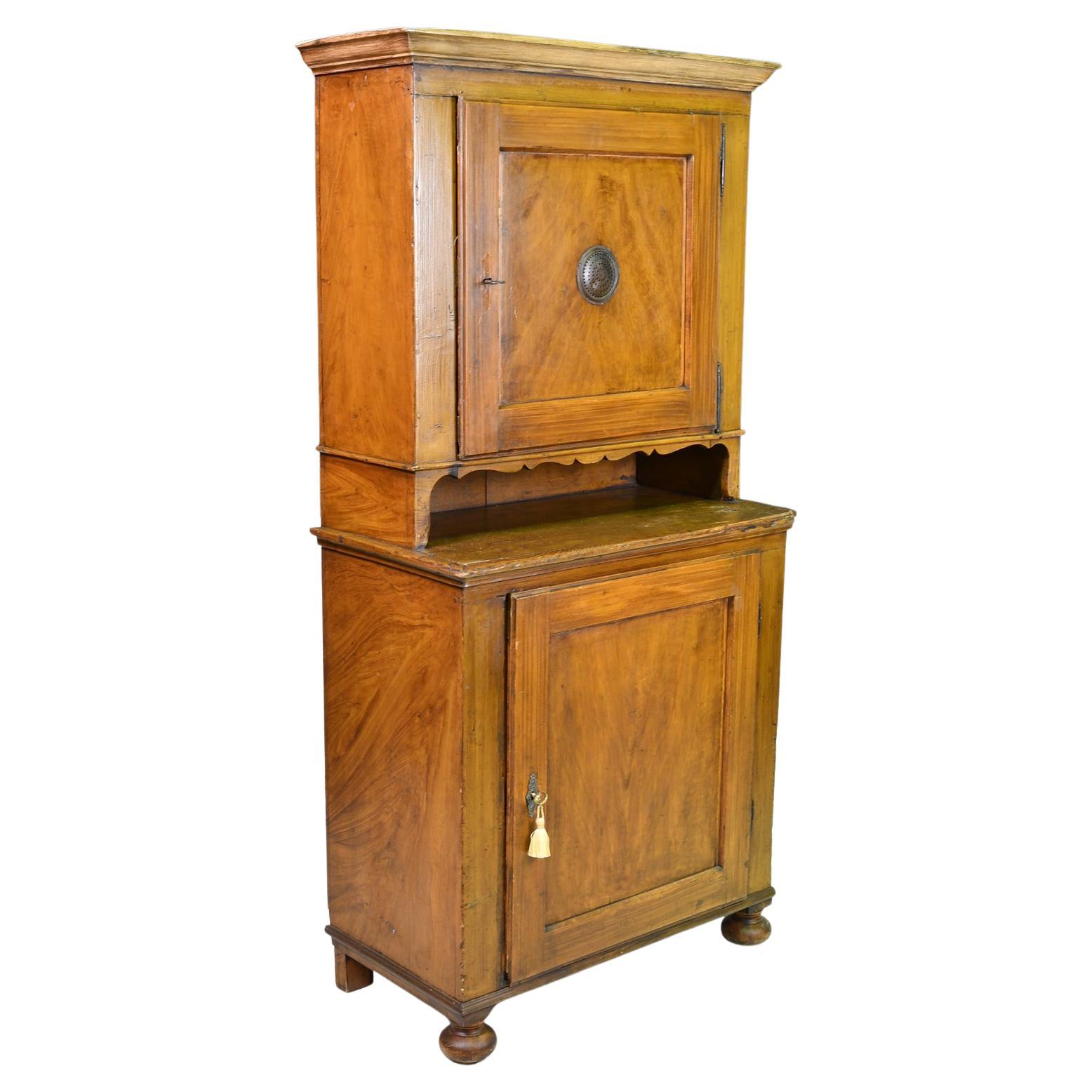 A charming country cupboard with the original faux-bois, tooled & grained painted finish. Underlying wood is pine but this wonderful cabinet was spared being stripped and waxed in the 90's. Lap joint and mortise and tenon construction with wooden