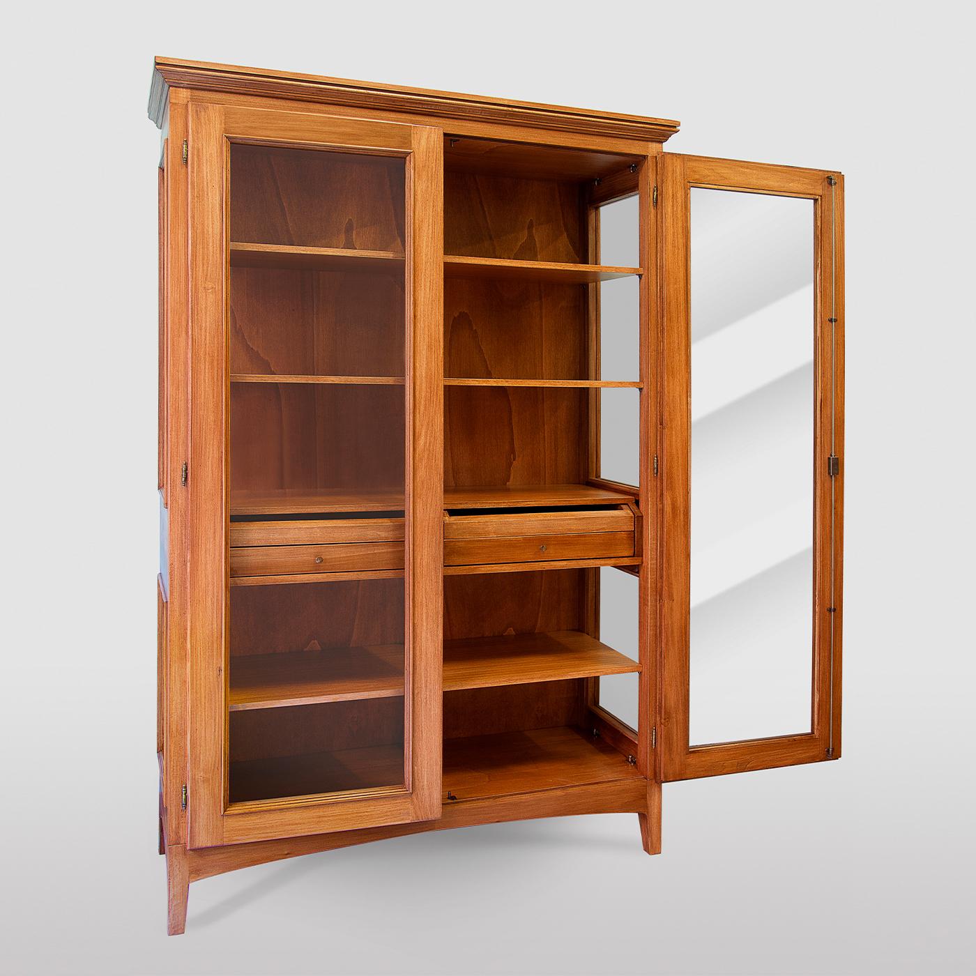 This display cabinet in walnut-stained, solid tulipwood is a true gem that will surely make a superb statement in any classic or rustic-chic decor. Raised on tapered feet, the handcrafted structure is adorned with overlapping frames outlining the
