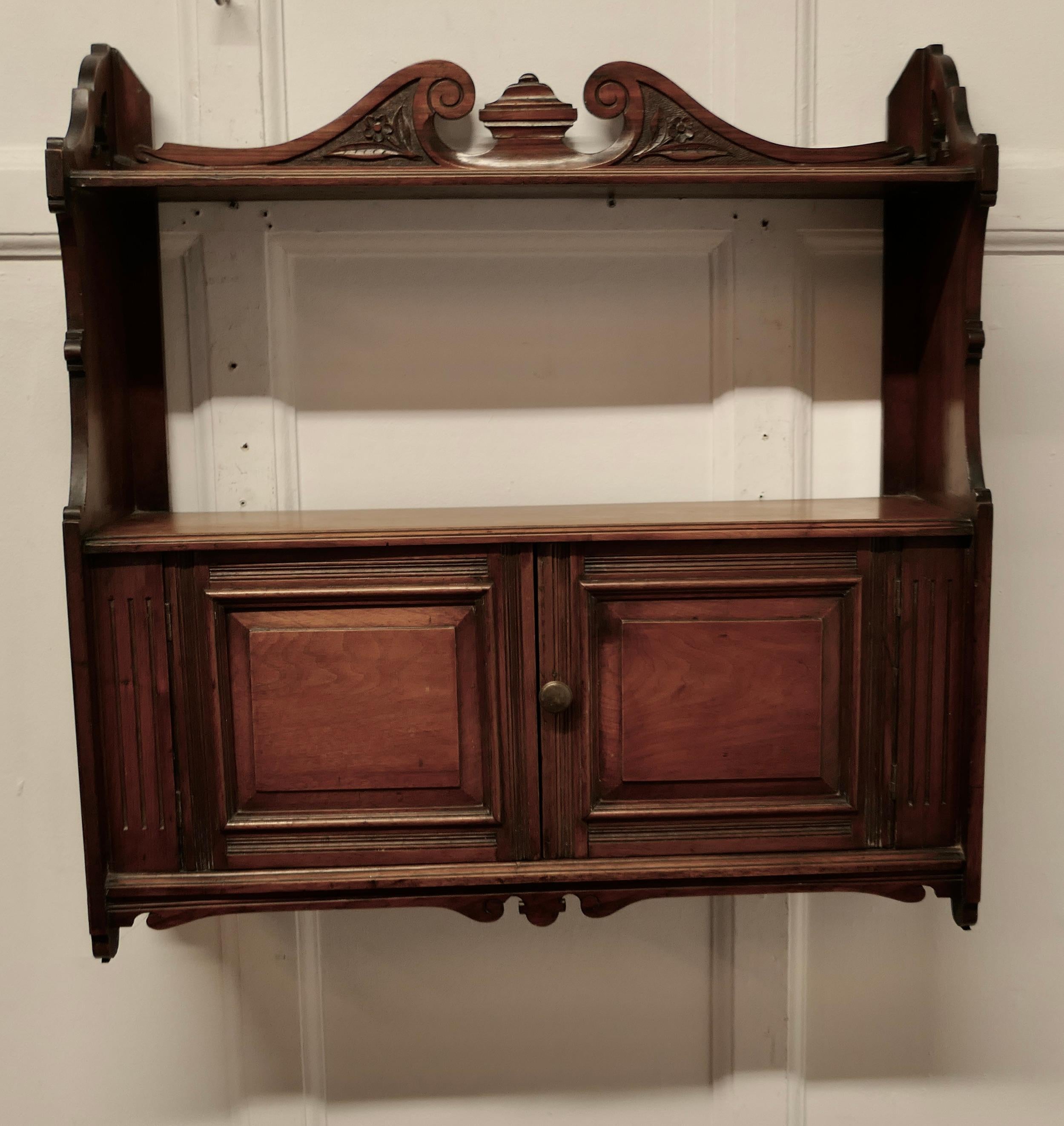 2 Door Walnut Wall Cabinet 

A great little piece, made in walnut, the cabinet has a top shelf decorated with a Swan Neck pediment and more storage inside the 2 door cabinet
Just the thing in a small bathroom or downstairs cloakroom where storage is