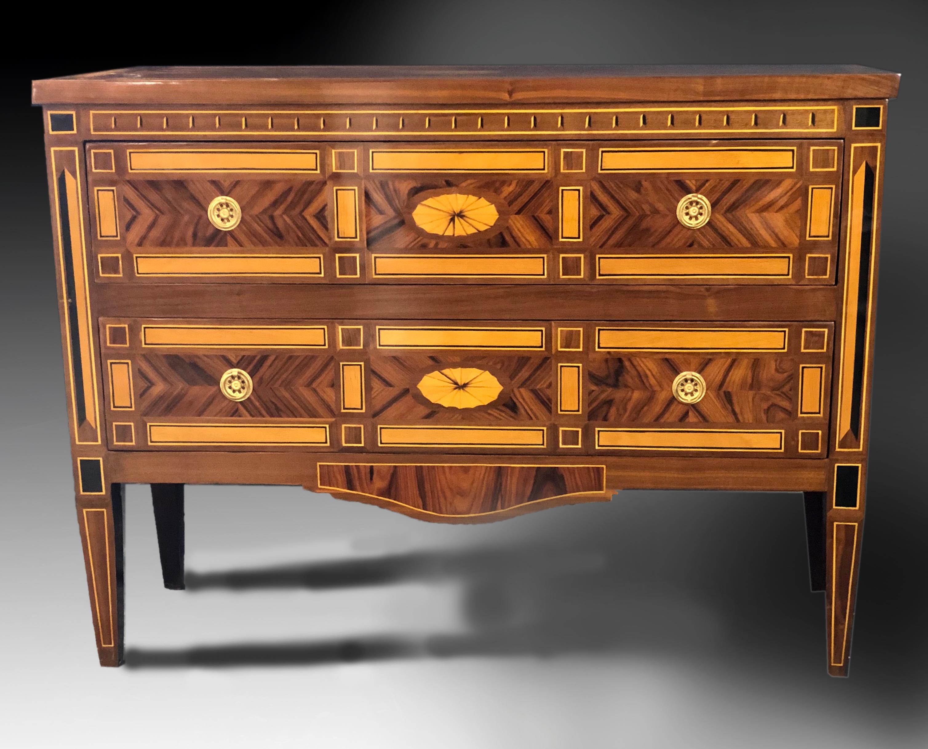 Outstanding 2-drawer parquetry commode that would adorn any entry hall due to its shallow depth and stunning appearance. Profusely veneered with figured Indian rosewood, American walnut and maple as well as African ebony. Masterful workmanship, good