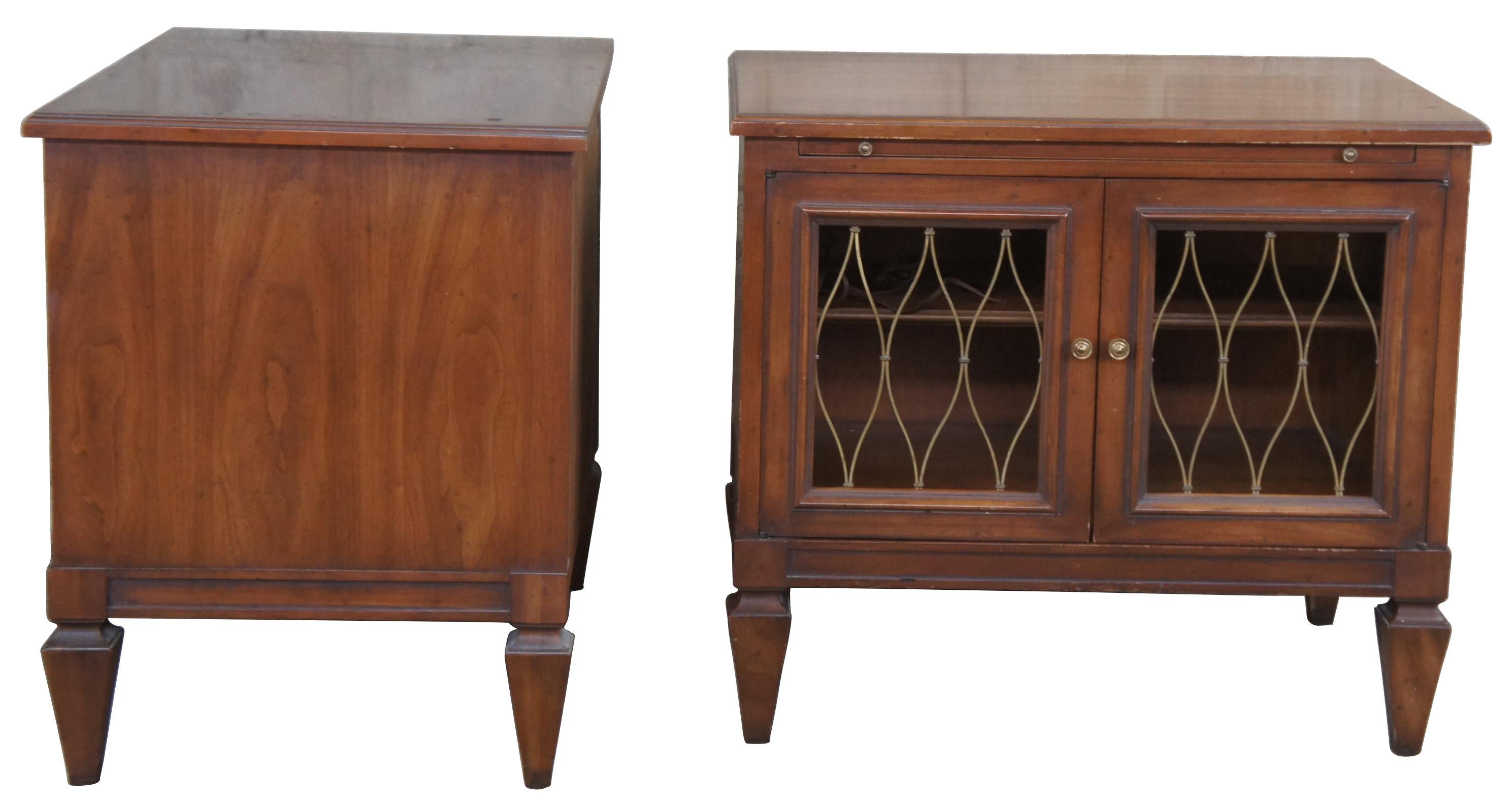 Circa 1960s Drexel Heritage Movanti Mediterranean collection nightstand/ side tables,14-172-30. Drawing inspiration from early Renaissance, Italian, classical and other European designs. A rectangular form made from fruitwood with brass grille doors