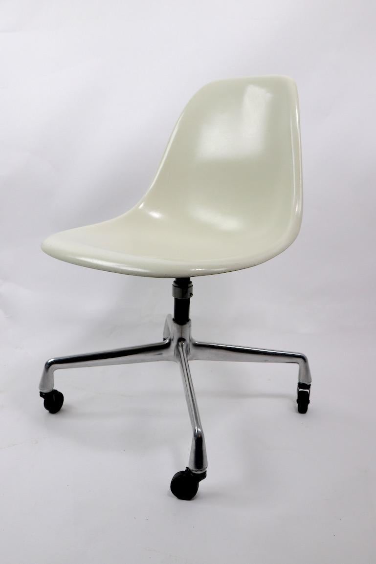 Hard to find Eames form, fiberglass shell on aluminum group bases. The ivory shells swivel on the vertical post, the aluminum bases are mounted on original wheel coaster feet. Offered and priced individually, but we would love to see them stay