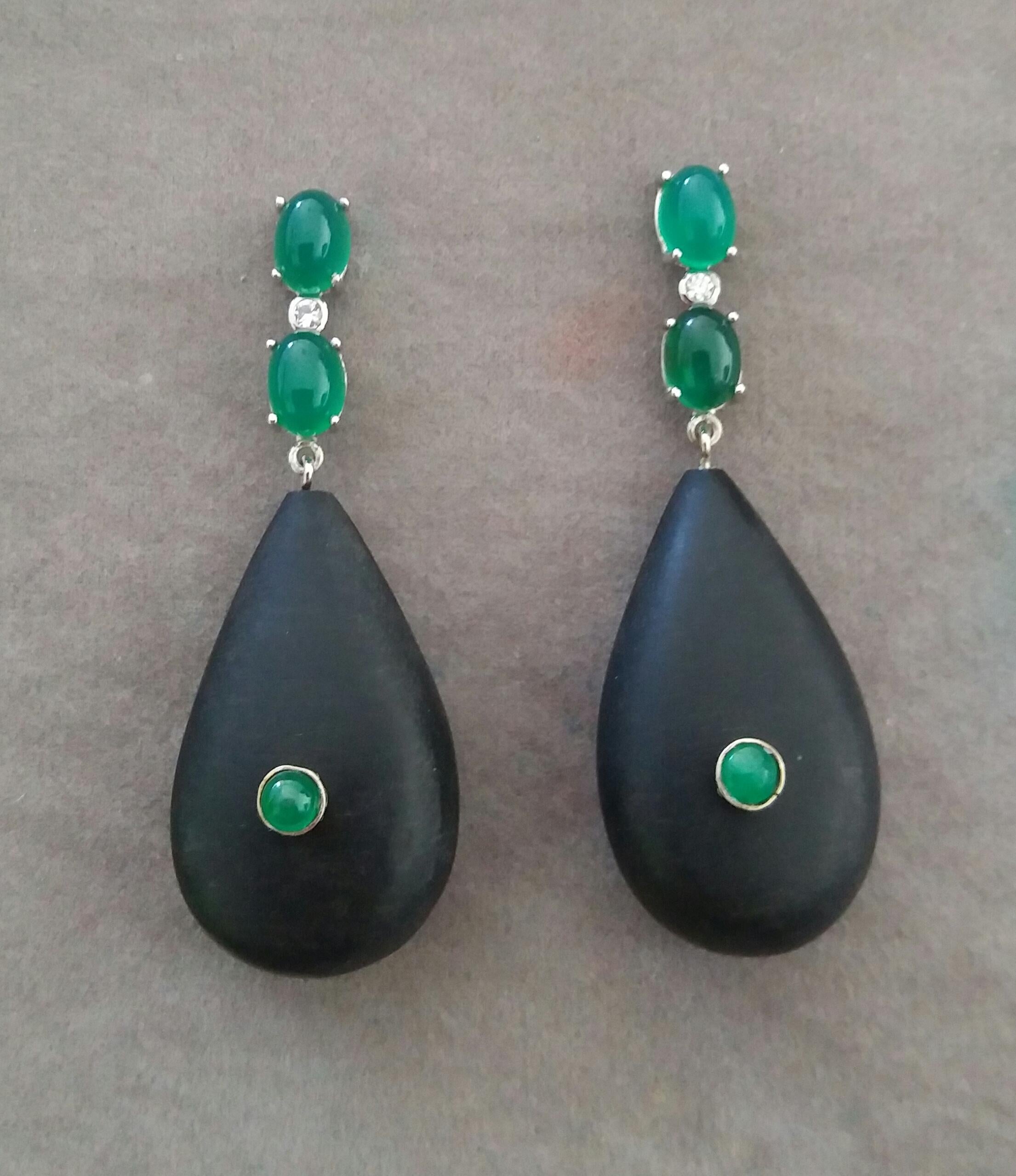 Elegant and completely handmade Earrings consisting of an upper part of 2 oval shape Emeralds cabs of 4 mm x 5 mm set together in 14 Kt white gold with a  small diamond in the middle, at the bottom 2 Natural Ebony Plain Drops measuring 18 x 30 mm