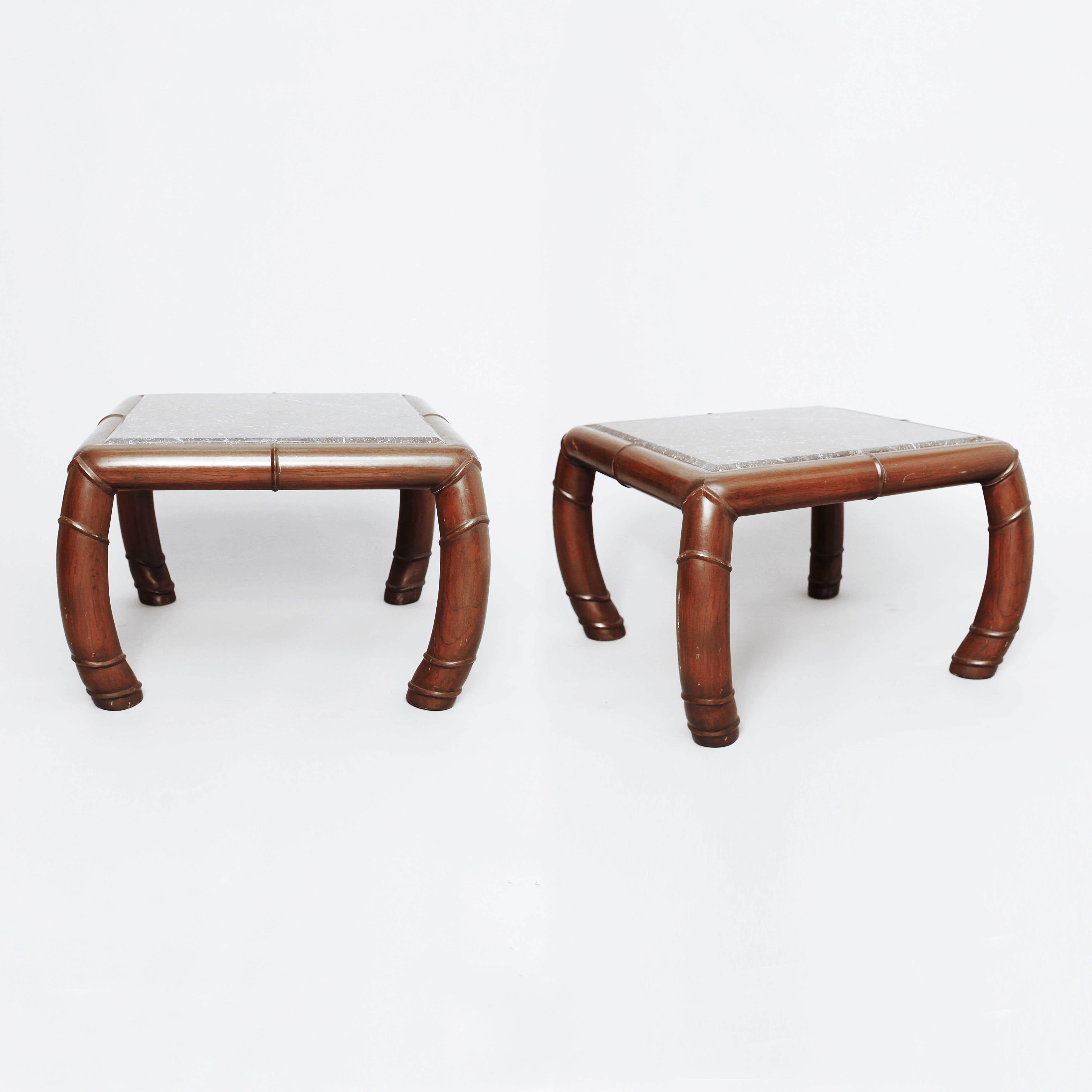 Unique pair of large faux-bamboo side tables with a grey, veined marble top. Solid and heavy pair of end tables with curved legs and bevelled marble top. Very elegant design, and the epitome of Hollywood Regency style, imported from the