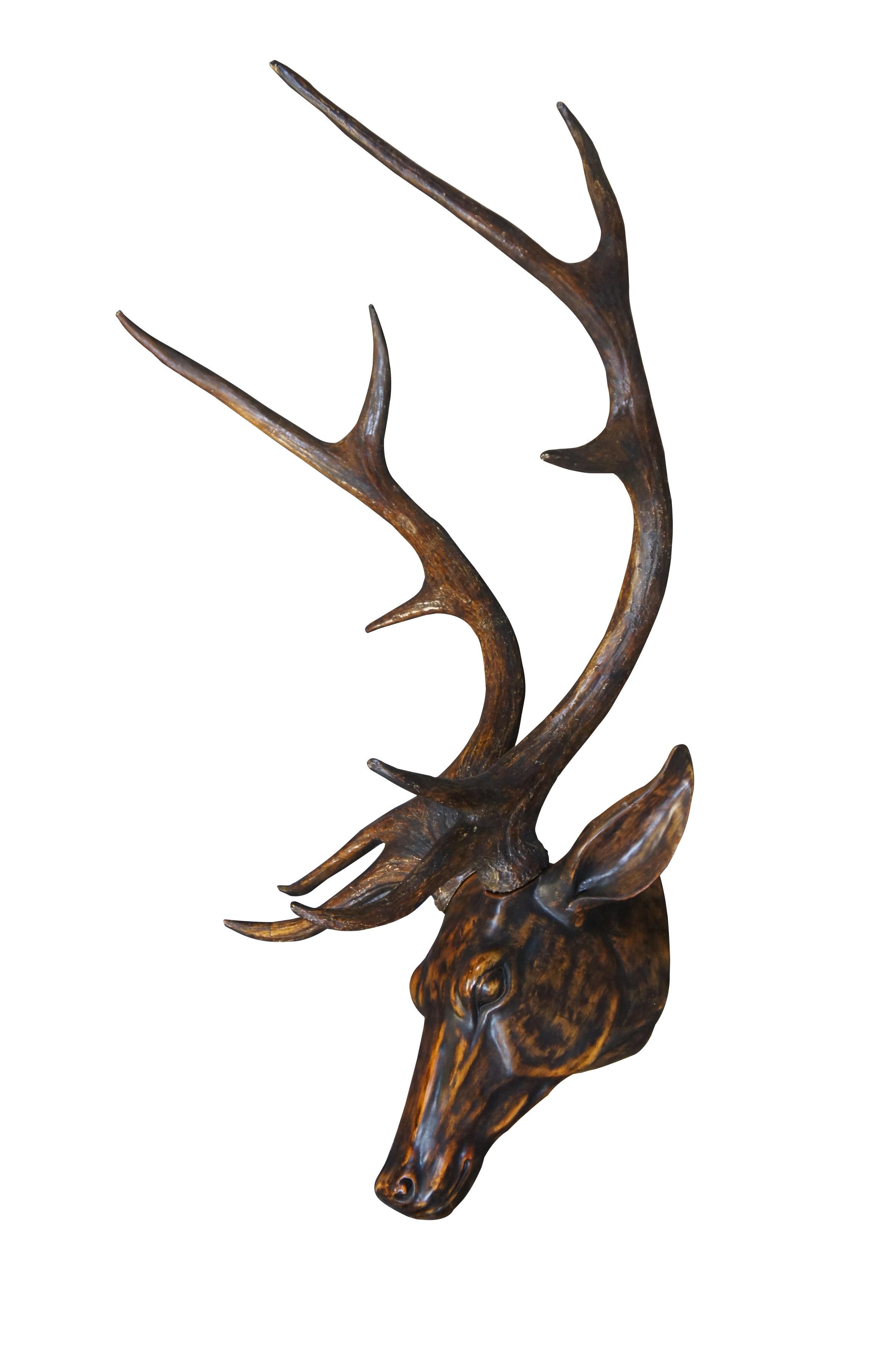 Pair of late 20th century wall hanging faux taxidermy deer / buck head sculptures with long antlers. Made of resin and painted to resemble carved wood. 

Dimensions:
29