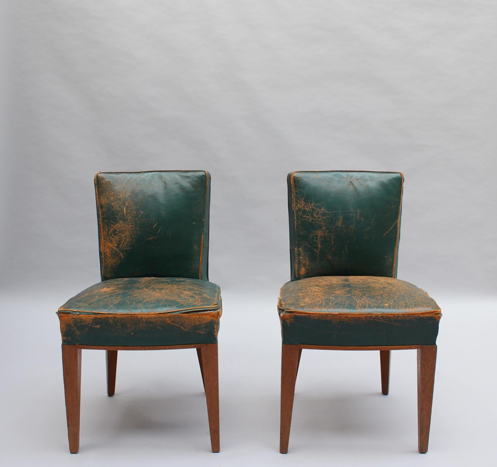 Two fine French Art Deco side chairs in solid oak.