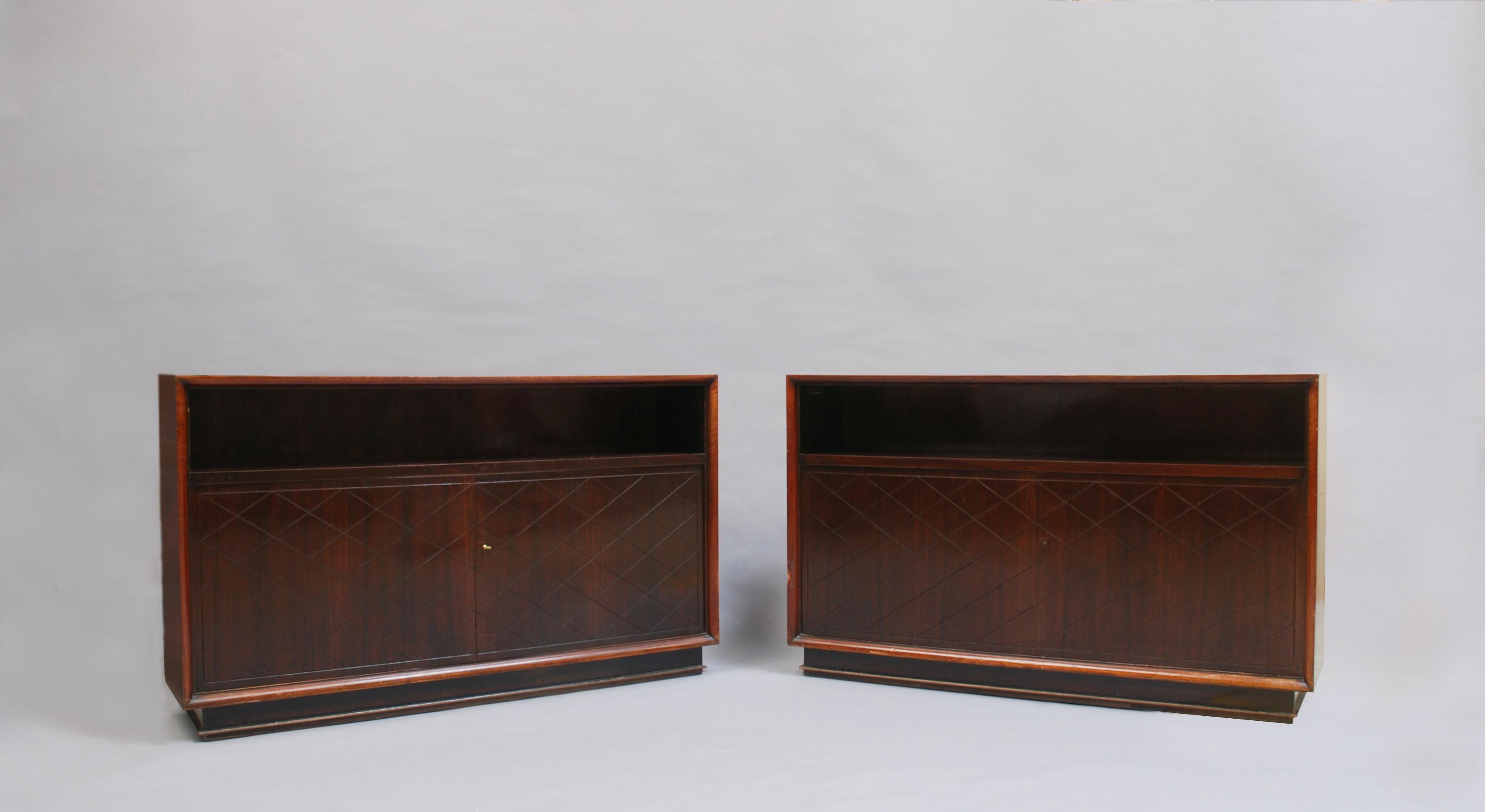 Two Fine French Art Deco rosewood cabinets/consoles by Jean Pascaud.
Small difference in the interiors shelving (see pictures).
Signed.
Price is per cabinet.