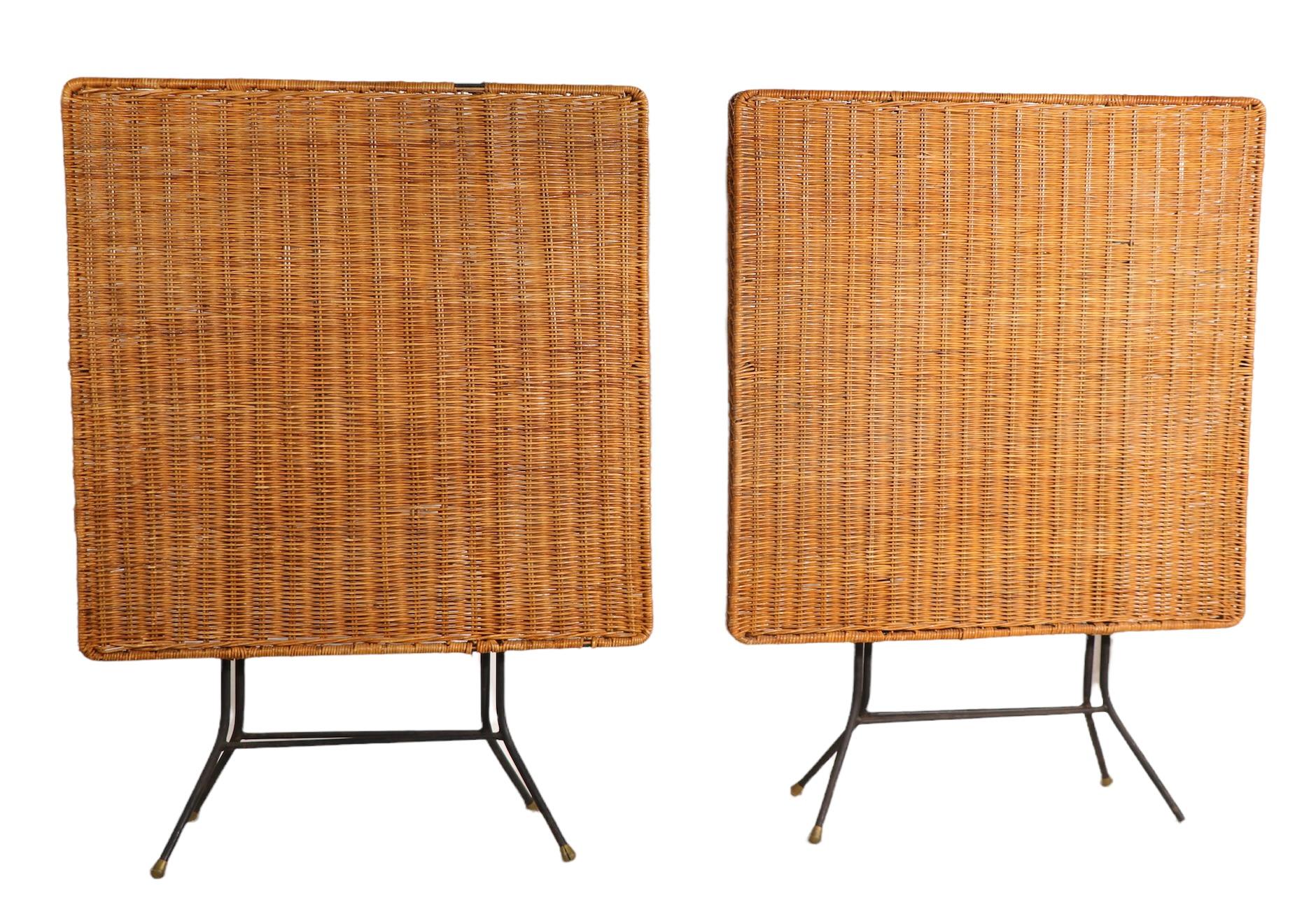 Chic folding card, cafe, or dining table(s) by California designed Danny Ho Fong. The tops are of woven wicker, the bases are tubular metal. One table has some loss to the wicker top, one is undamaged, both may be missing plastic feet glides. We are