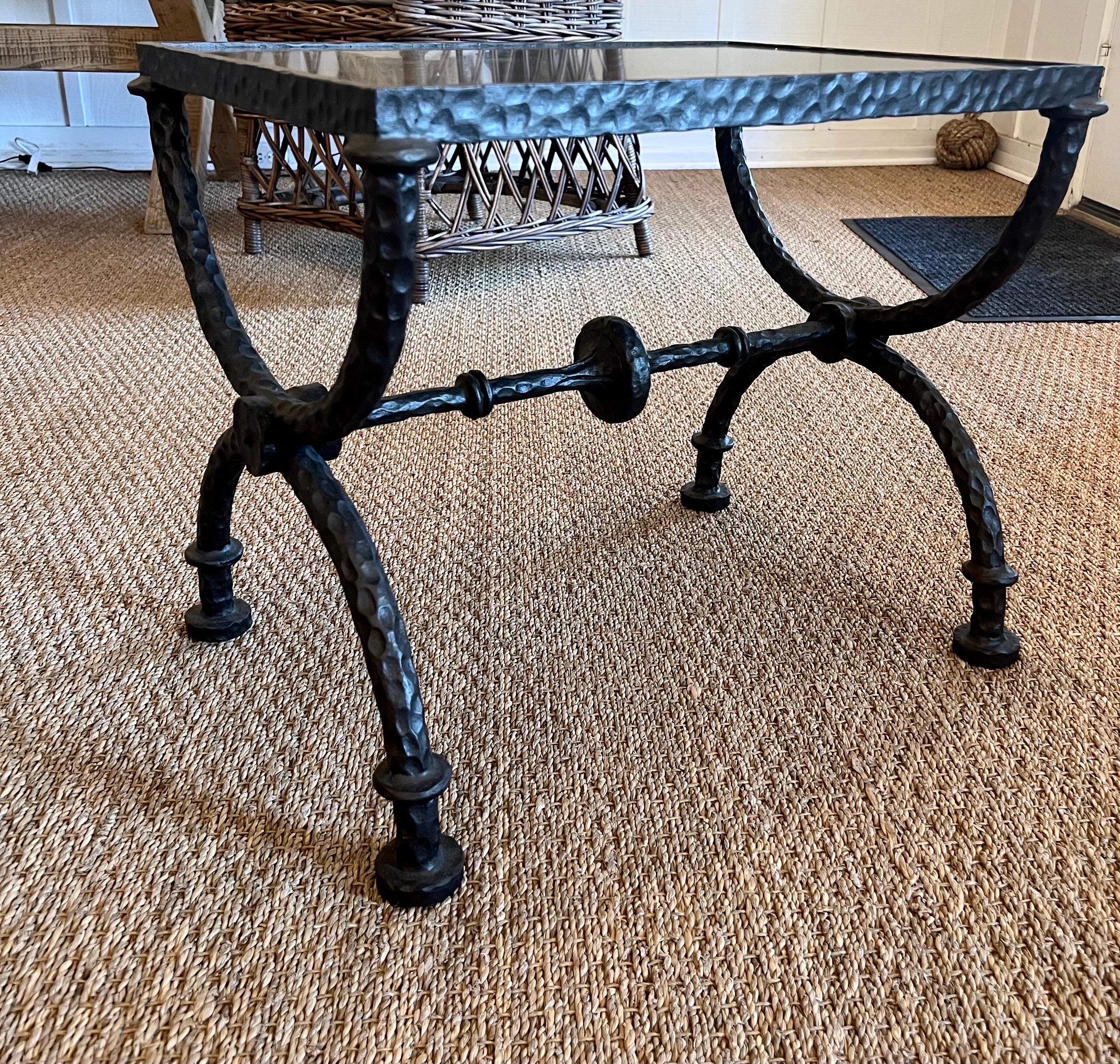 2 Elegant French Mid-Century Modern Style Hand Wrought and Hand Hammered Iron Benches or Side / End Tables in the style of Alberto and Diego Giacometti. The benches / tables are composed in an iconic Curile X-form characteristic of the Giacometti's