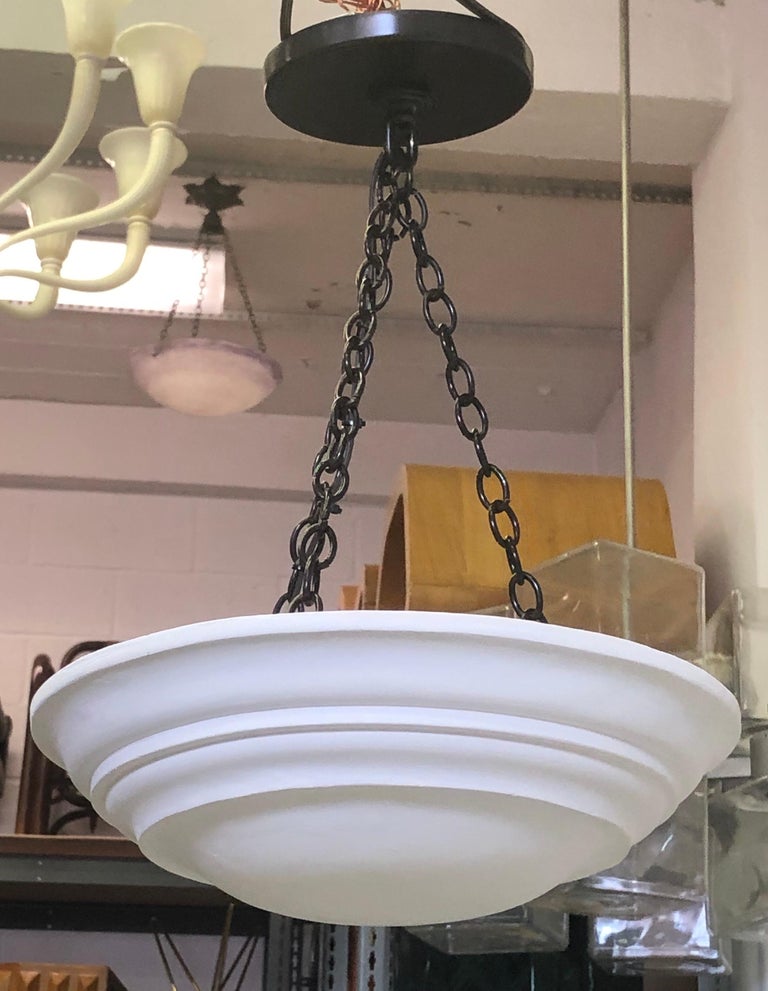 2 French Mid-Century Modern neoclassical style pendants / chandeliers in the style of Jean Michel Frank. The chain and canopy are in solid brass that has been bronzed. Solid brass patina is possible for the hardware.

These are priced and sold as