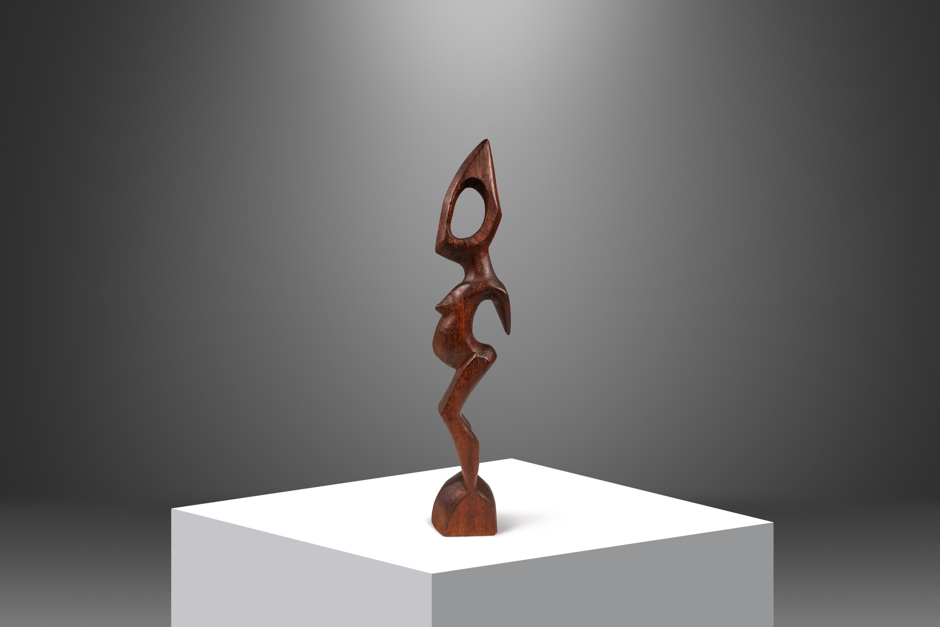 Fascinating and aesthetically gorgeous, this exquisite hand-carved sculpture is an excellent accent piece for those searching for authentic abstract African art. Hand-carved by craftsmen in west Africa from solid African mahogany this beautiful