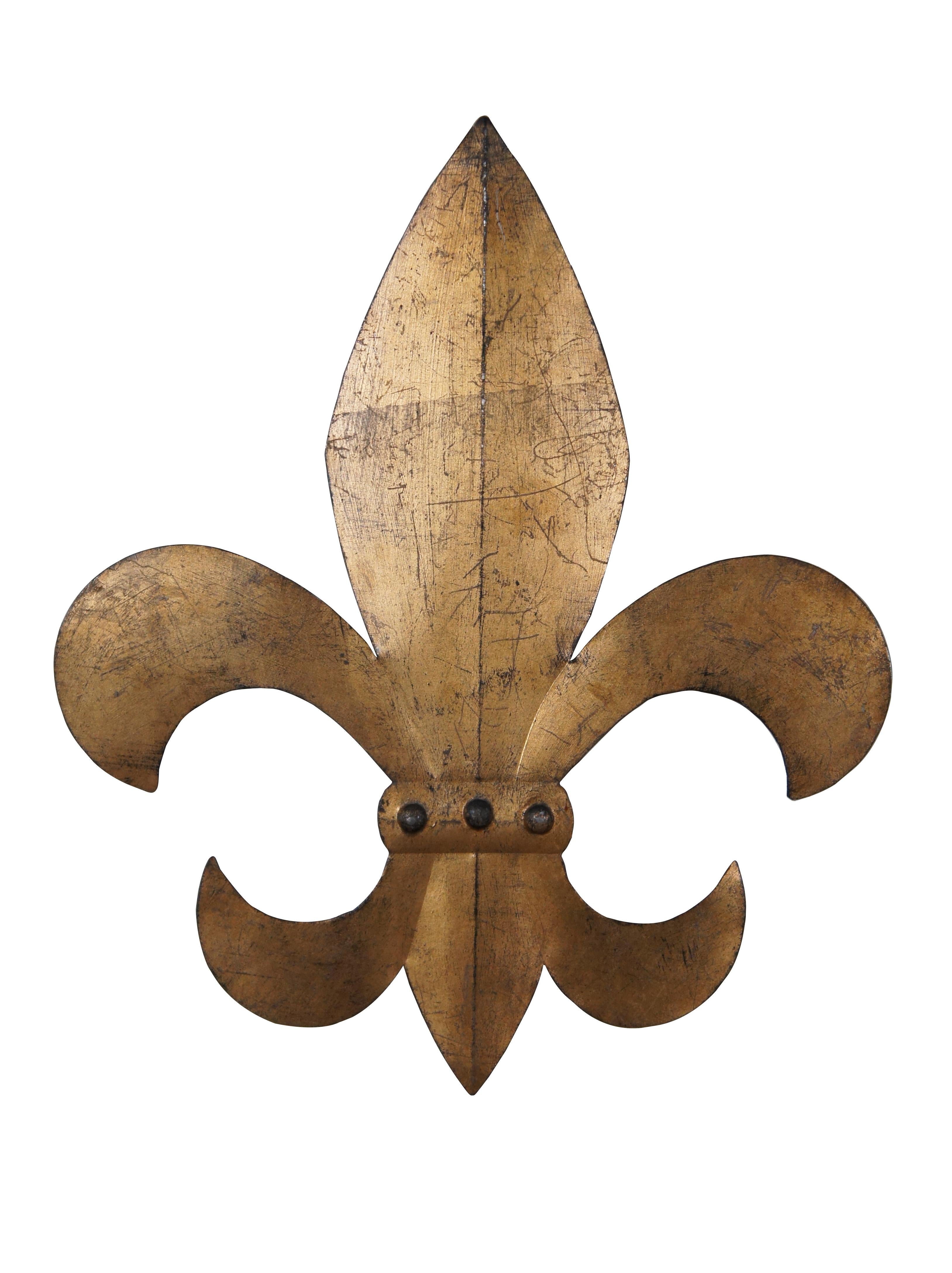 Vintage pair of gold painted Fleur De Lis wall art plaques.  The fleur-de-lis, also spelled fleur-de-lys, is a common heraldic charge in the shape of a lily. Most notably, the fleur-de-lis is depicted on the traditional coat of arms of France that