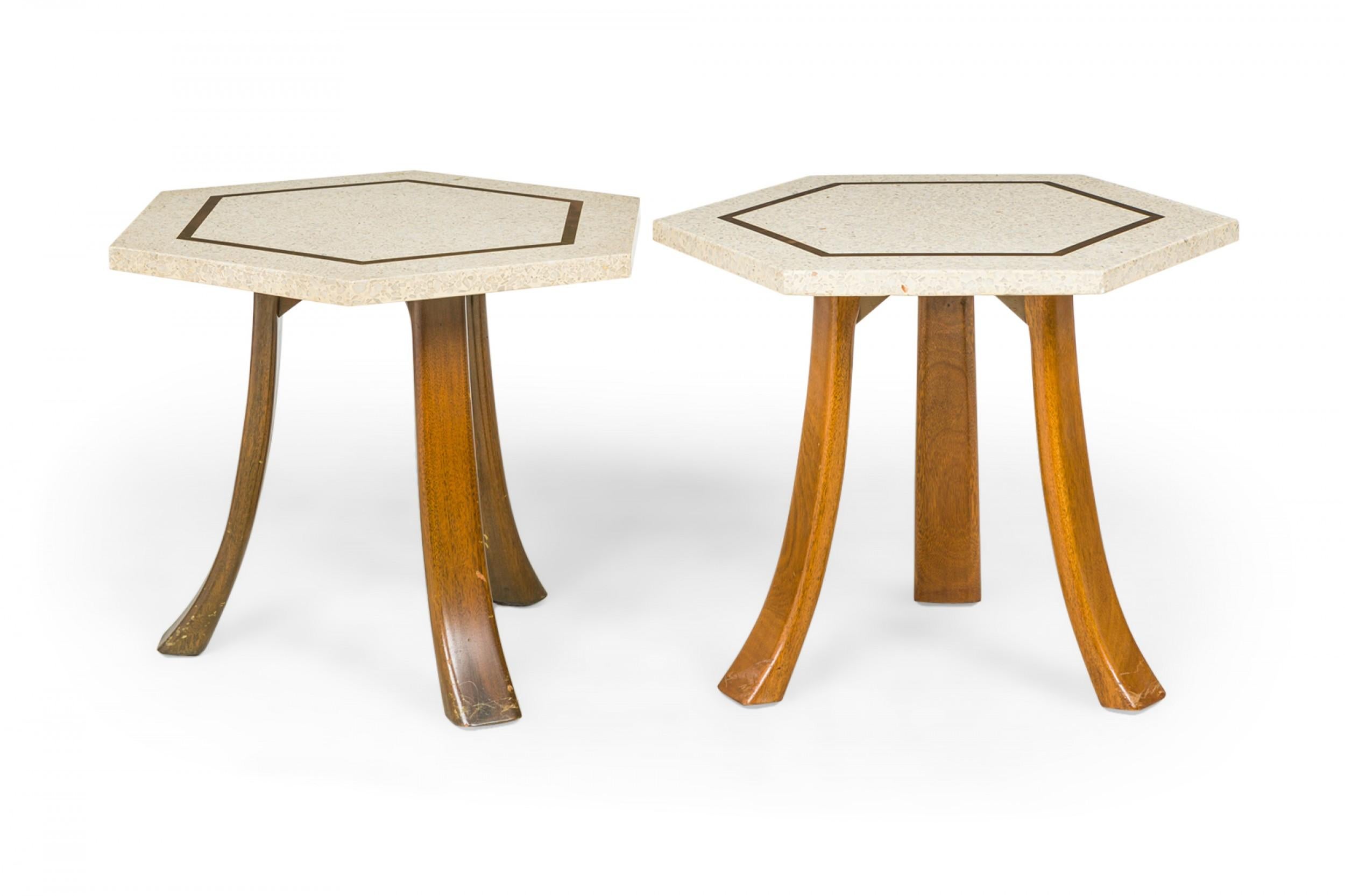 2 American mid-century end / side tables with hexagonal white terrazzo tops with a bronze inlaid hexagonal design supported on three curved wooden legs. (Harvey Probber)(Priced Each)(Similar tables: DUF0356A-E).
    