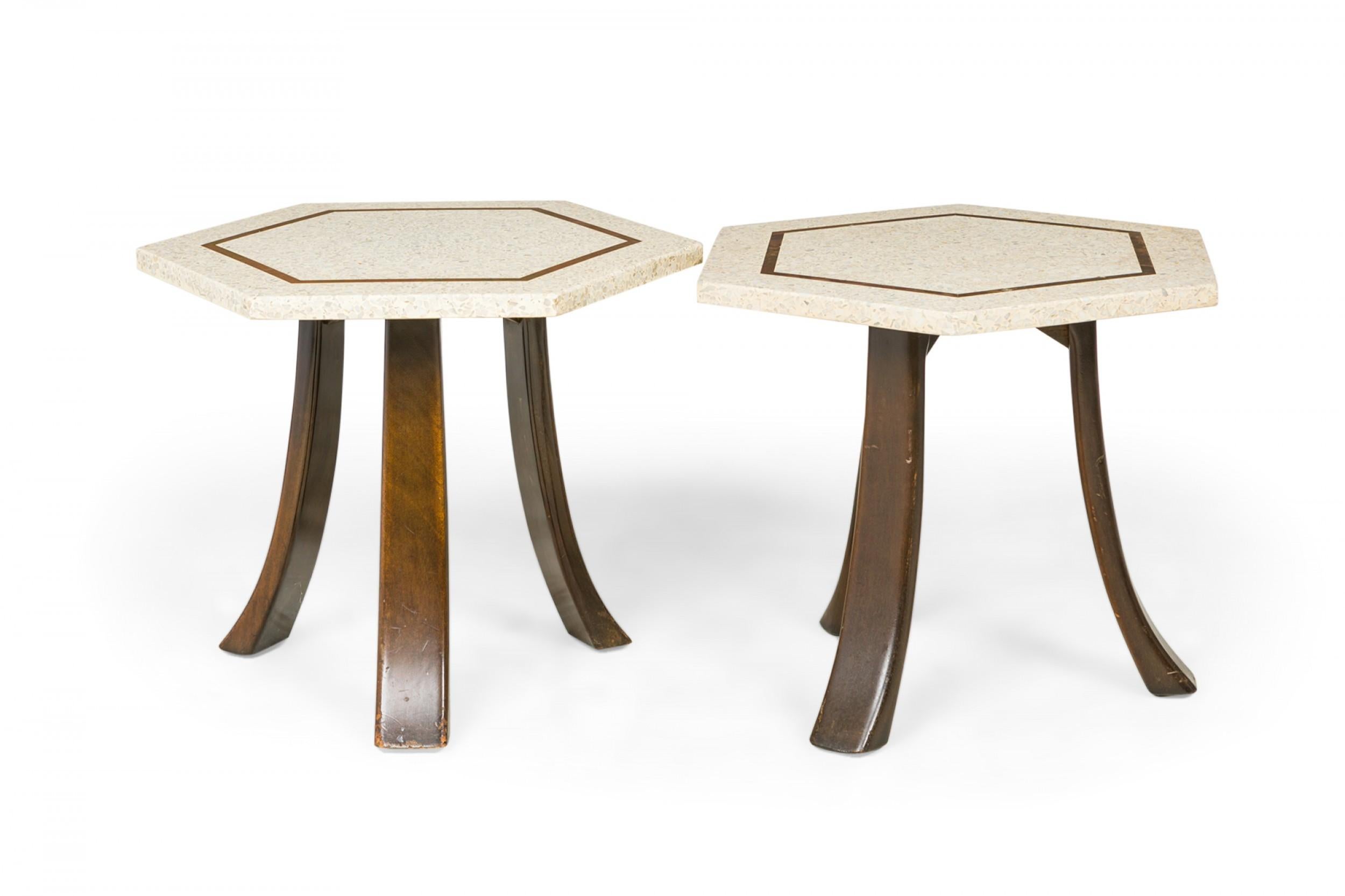 2 American Mid-Century end / side tables with hexagonal beige terrazzo tops with a bronze inlaid hexagonal design supported on three curved dark wooden legs. (HARVEY PROBBER)(PRICED EACH).
 