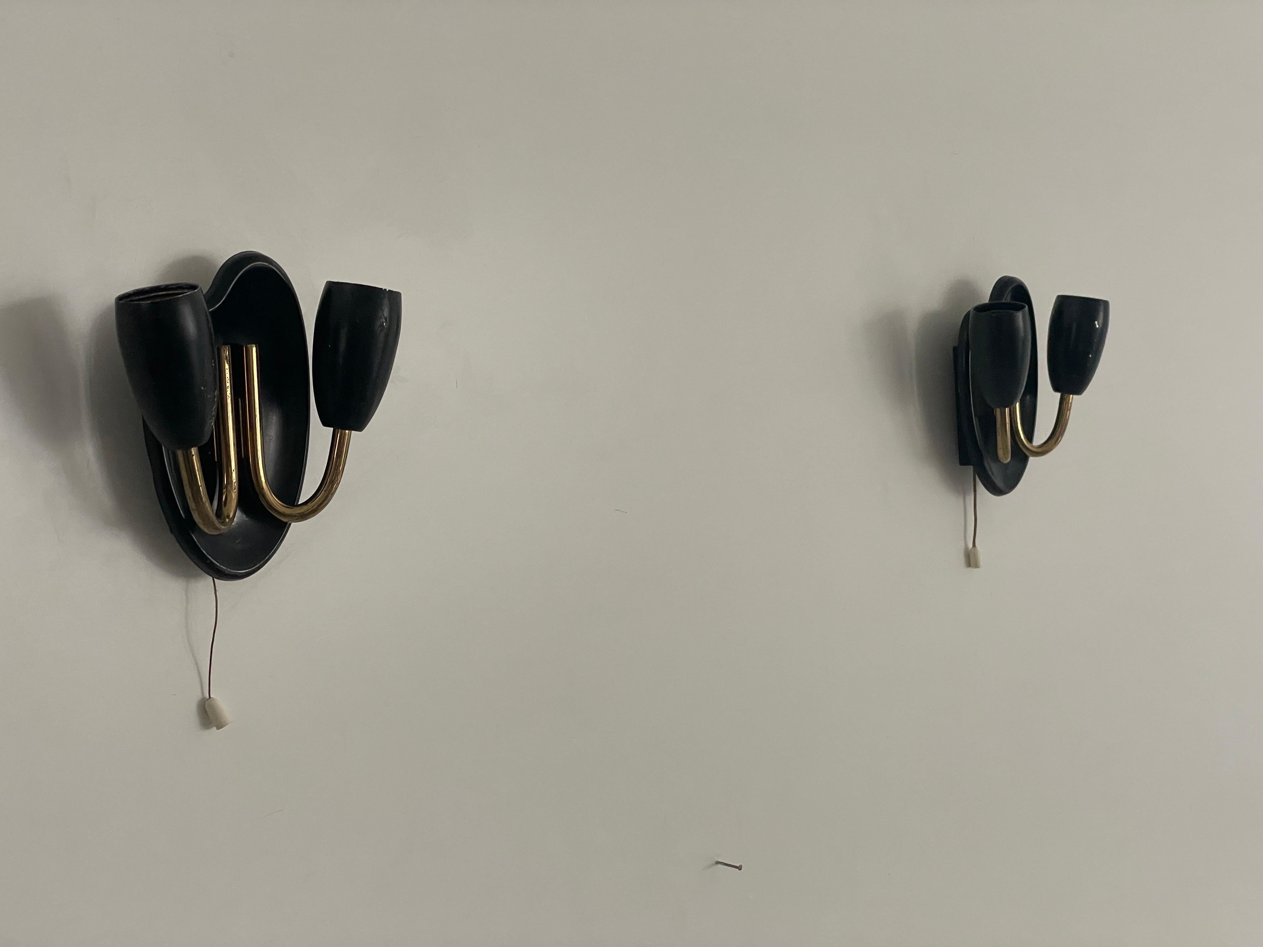 Coppia di piccole lampade a 2 teste in metallo nero, anni '50, Germania

Lampade da parete molto eleganti e minimaliste
Le lampade sono in ottime condizioni.
2 coppie disponibili

Queste lampade funzionano con 2x lampadine standard E14. 
Cablato e