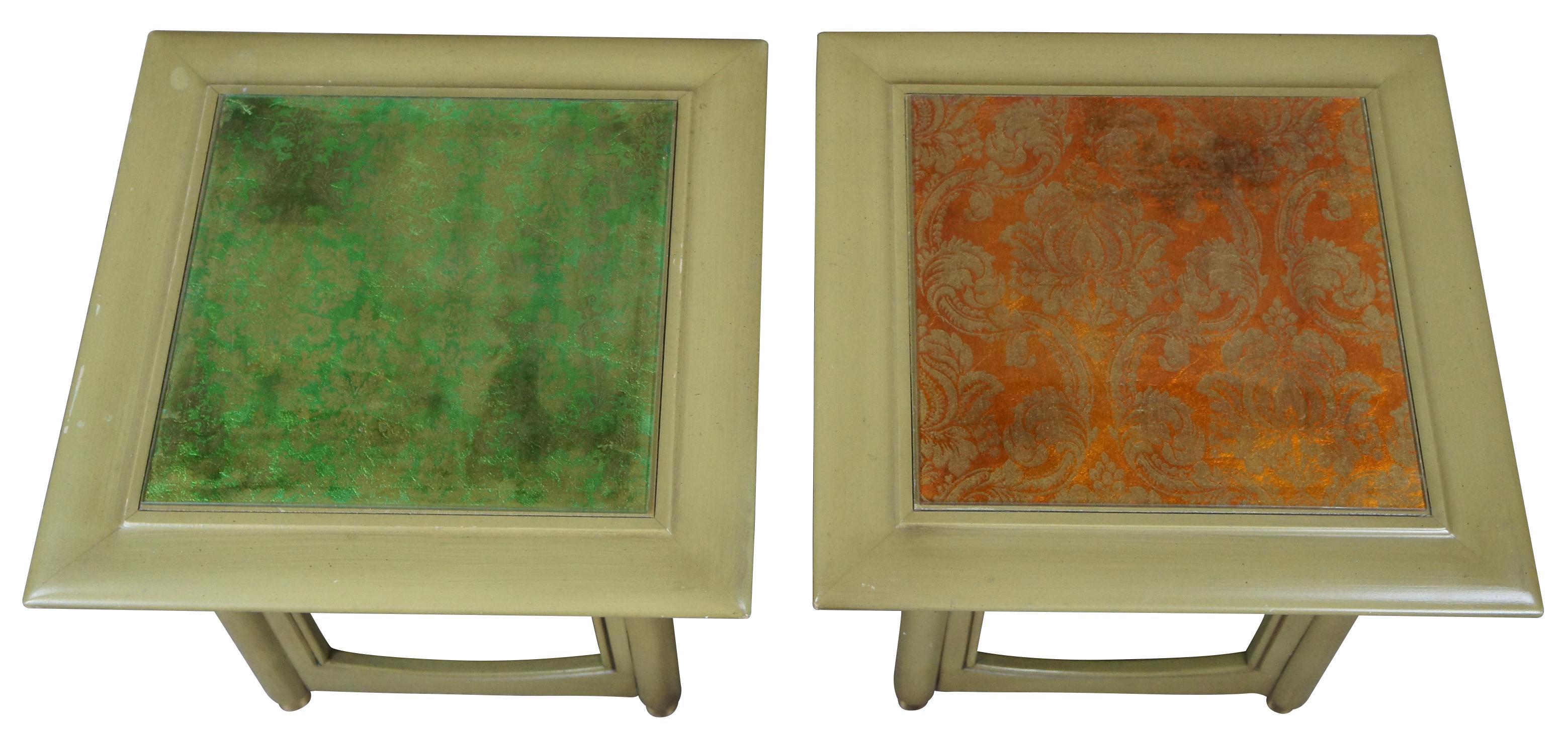 Pair of Hekman square accent tables. Made from wood with a distressed green finish. Features an open frame base with beveled glass tops. Each top is set over a french brocade. One is orange and the other is green