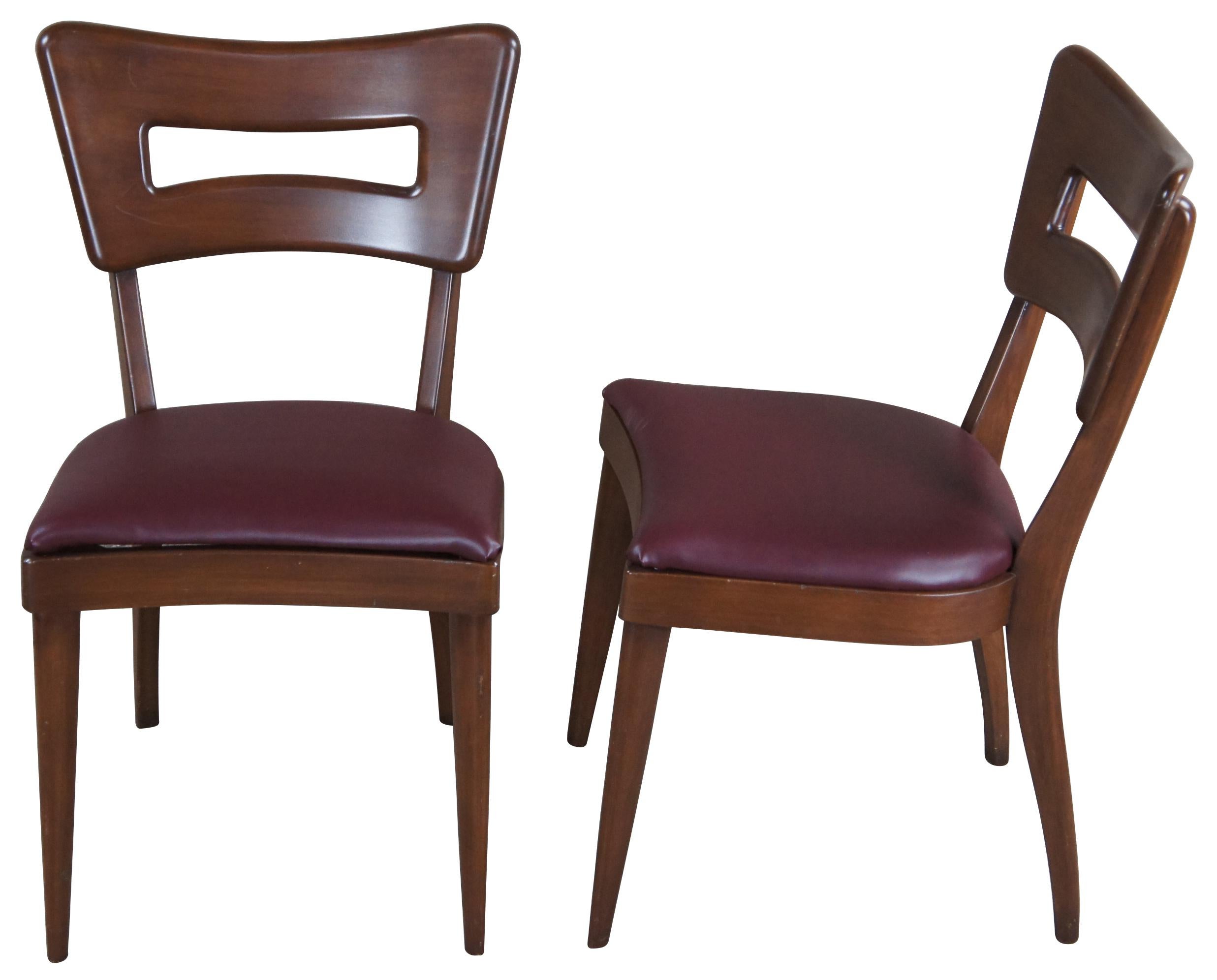 Heywood Wakefield sculpted dogbone dining side chairs, circa 1970s. Features a burgundy vinyl seat. M-1554-A.