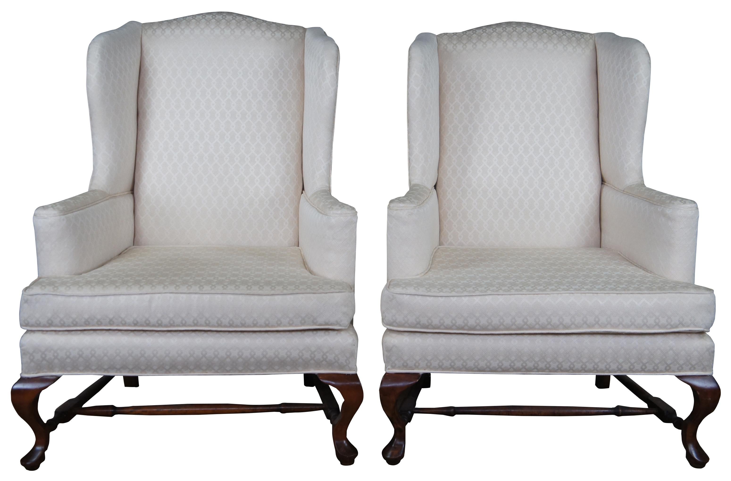 Pair of Hickory chair wingback armchairs. Made of mahogany featuring a white geometric upholstery and queen anne pad feet. Measures: 45