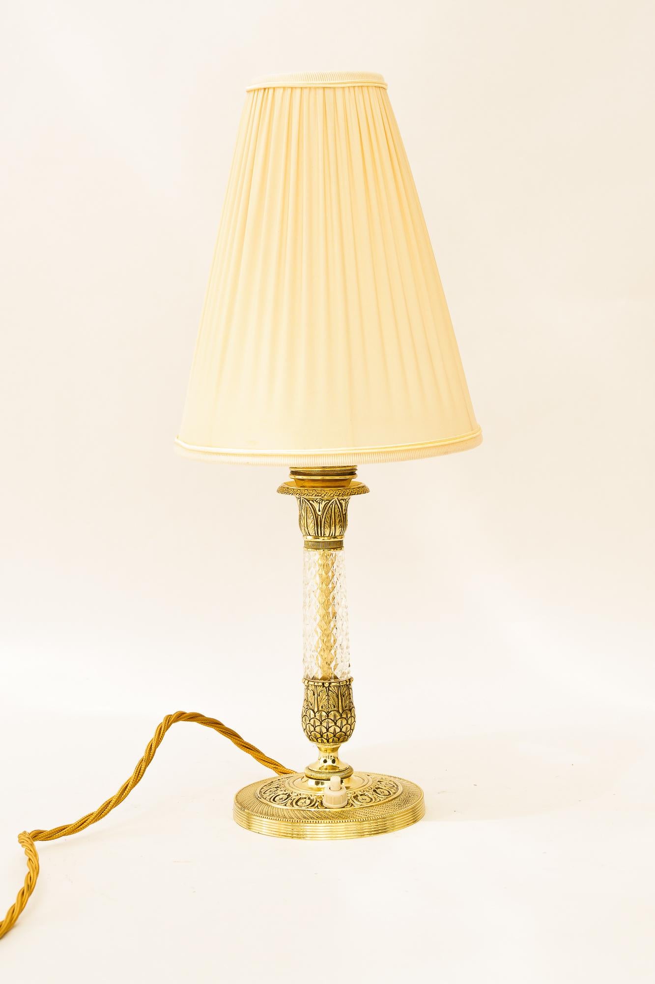 2 Historistic table lamps with fabric shades vienna around 1920s 
Solid brass
Very beautiful cut glass rods
Brass polished and stove enameled
The fabric shades are replaced ( new )
