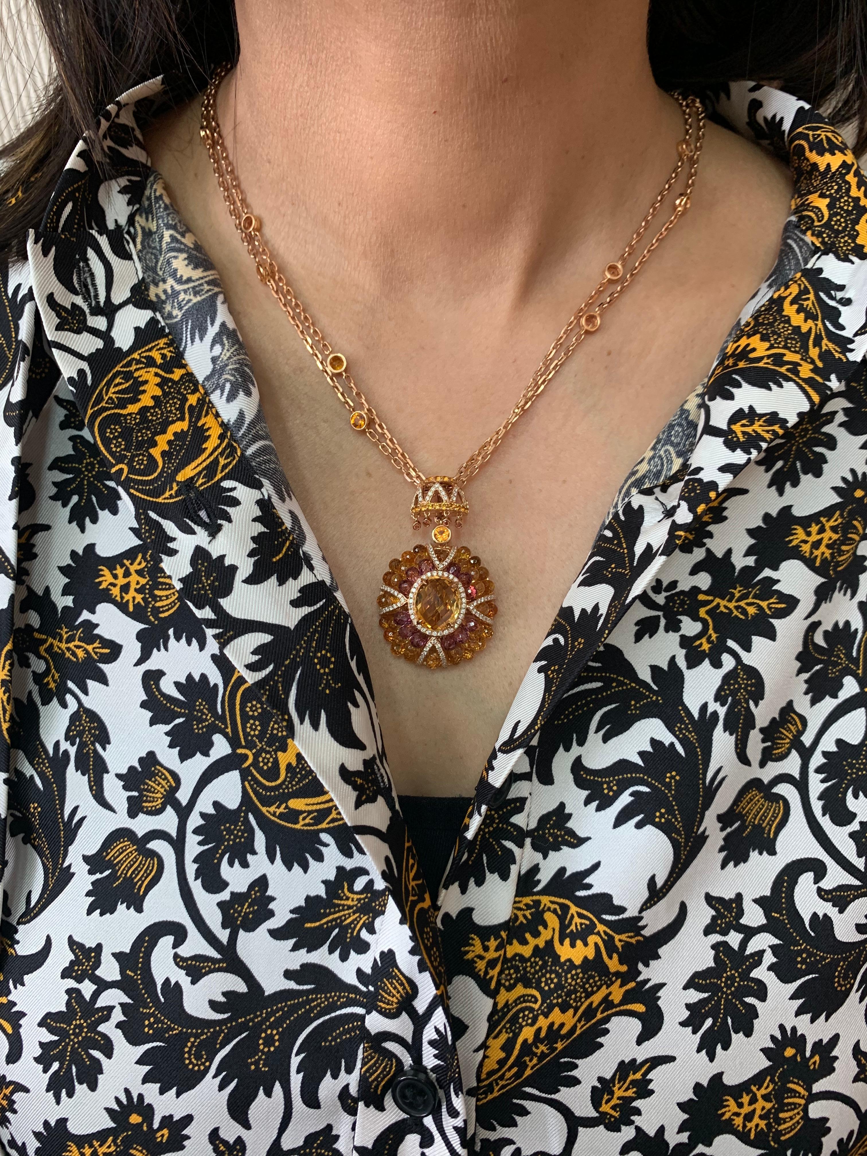 This is a chic citrine pendant necklace in a unique briollete cut to accentuate the colorful sparkle. The stunning center stone vibrantly sits on top of a cluster of beautiful citrine and rhodolite garnet drops. The unique architecture to construct