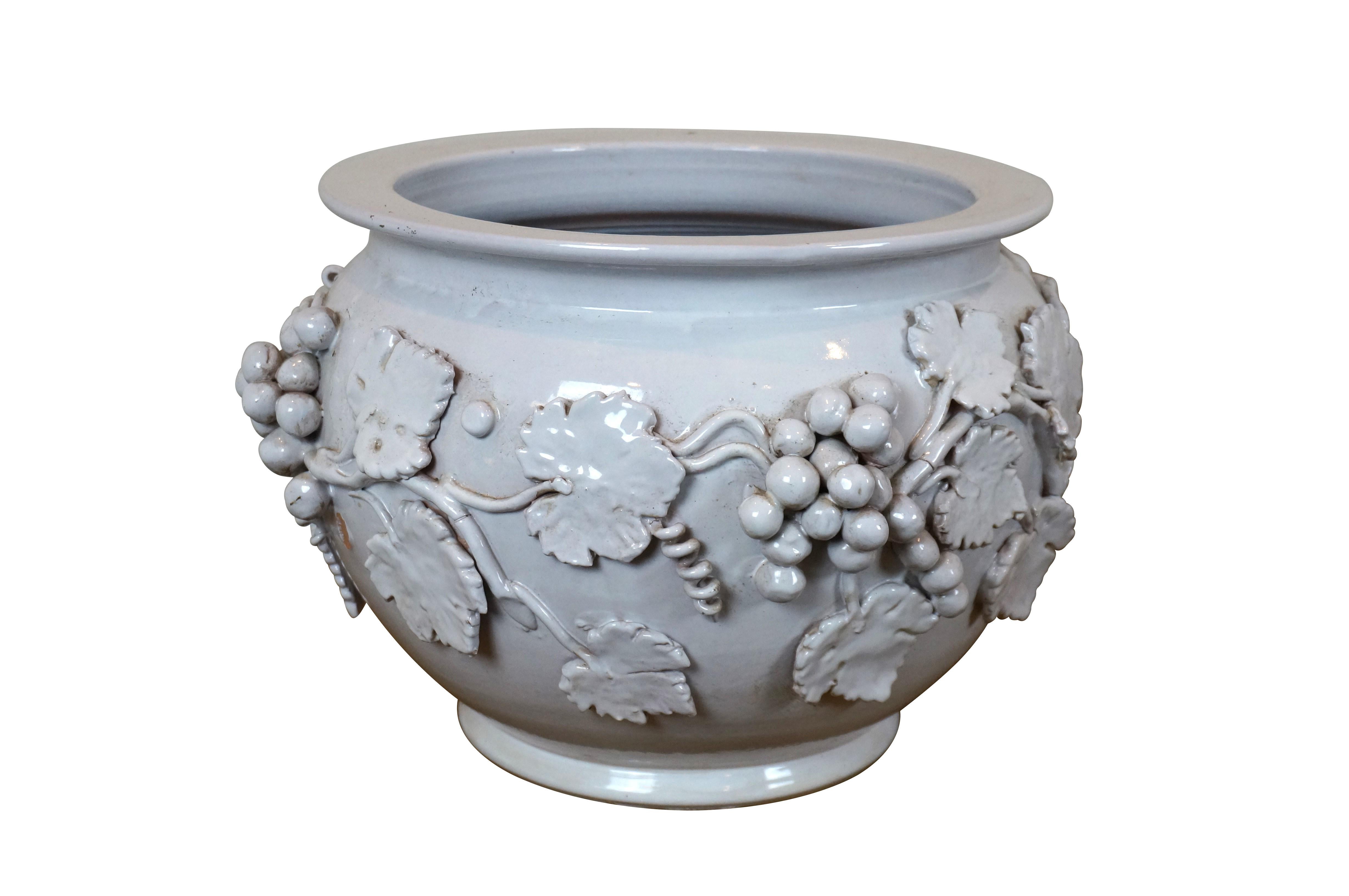 Pareja de grandes maceteros / jardineras / cacharros italianos Dolfi Otello Cottura blancos en forma de pecera, decorados con motivos en alto relieve de vides, frutas y hojas. Acabado en un grueso esmalte blanco con toques marrones cepillados por