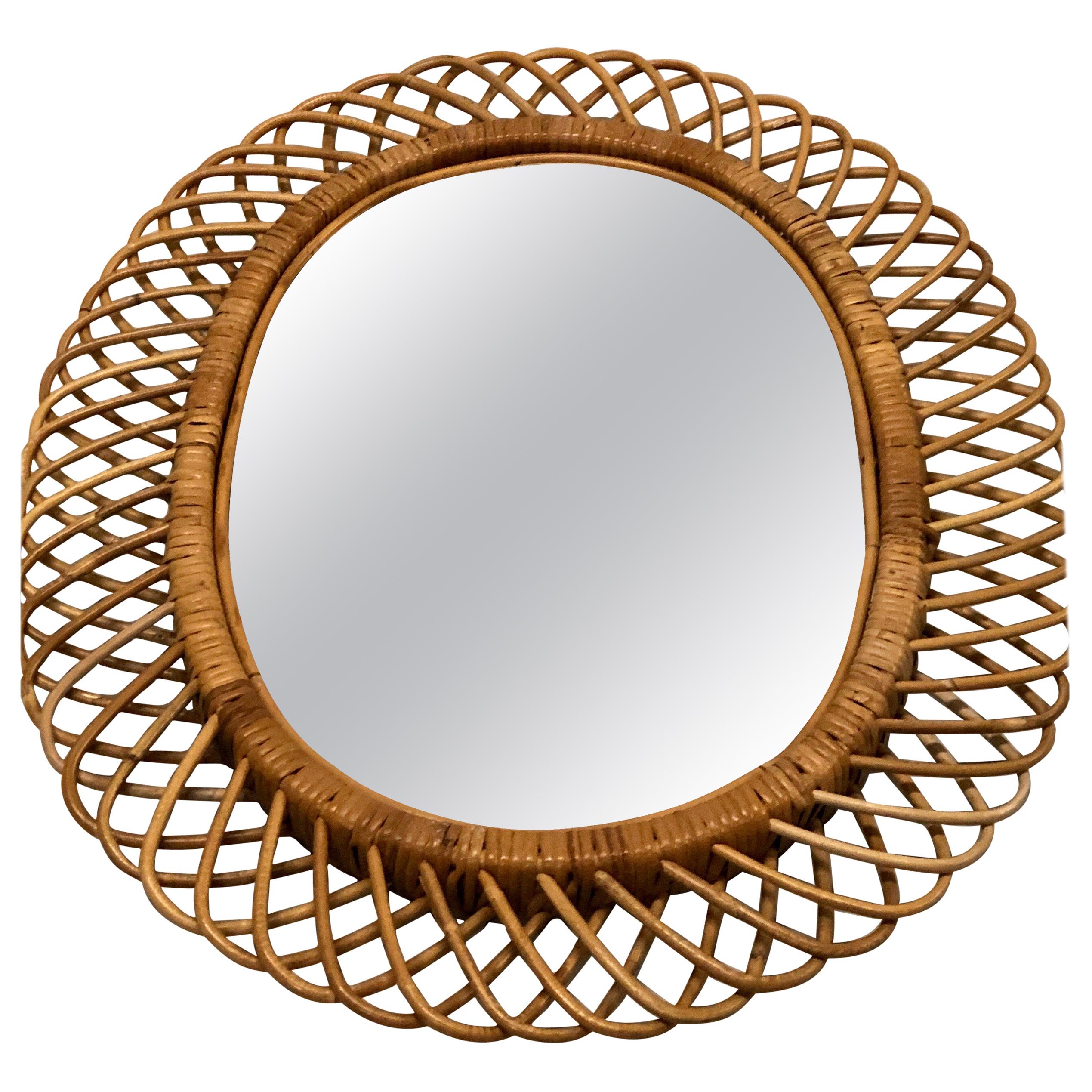 Two (2) Elegant Italian Mid-Century Modern rattan and bamboo wall mirrors in the style of Franco Albini circa 1950 to 1960. Each mirror is hand made and delicately shaped in the form of a crescent or sunburst. Each is in very good condition, Please