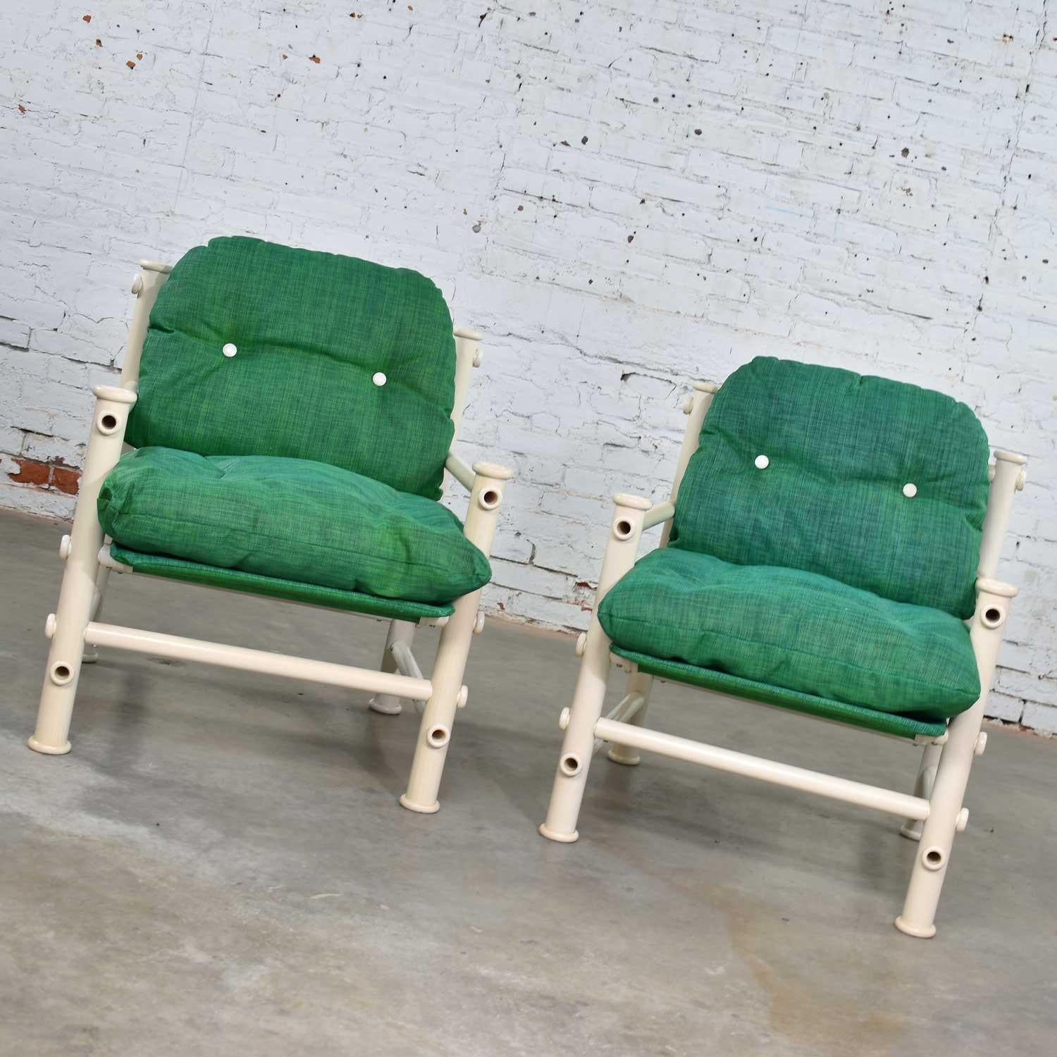 Fun and bright pair of white PVC Idyllwild outdoor lounge chairs with Kelly green mesh upholstery and sling designed by Jerry Johnson for Landes Manufacturing Co. They are in good vintage condition. There are signs of yellowing and some scratches to