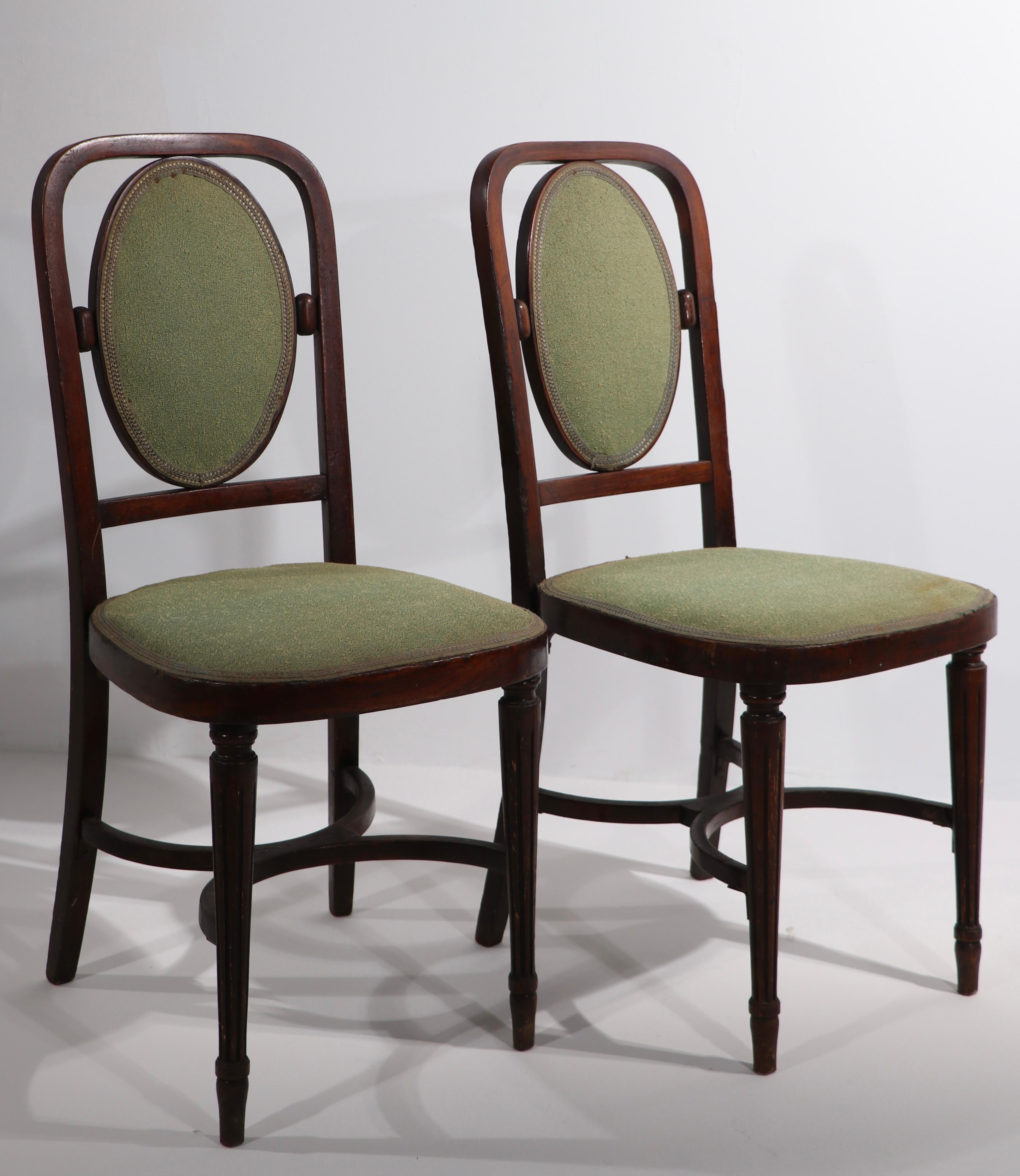 Near pair of Vienna Secessionist side chairs, design attributed to Joseph Hoffman. The chairs match with the exception of the back of the backrest, which is exposed wood on one, and upholstered on the other (see images). Both are structurally sound,