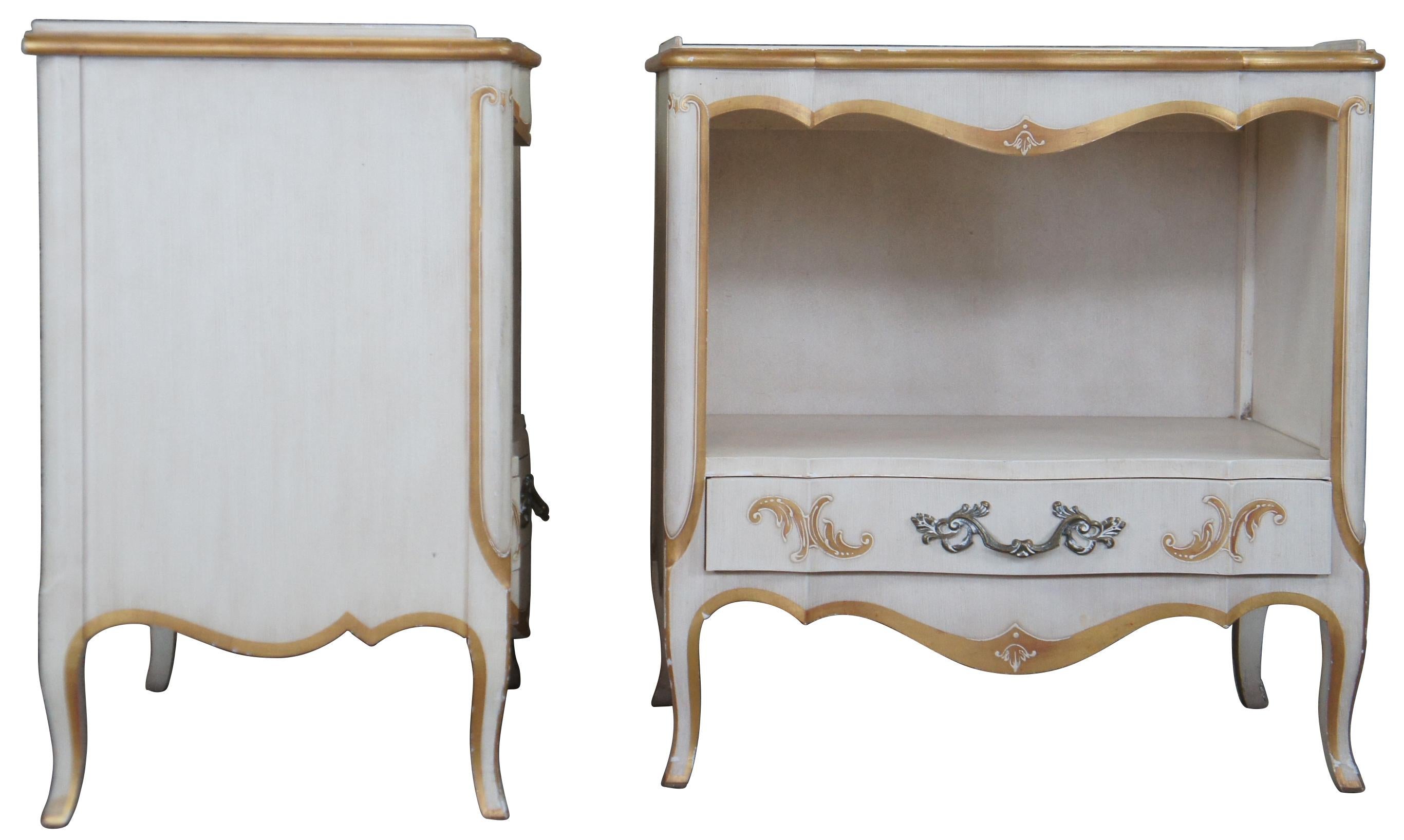 Pair of John Widdicomb Nighstands, circa 1960s. Drawing inspiration from Italian Florentine and Provincial. Features a rectangular form with serpentine front, central cubby, lower drawer and cabriole legs. Finished in antique white with gold