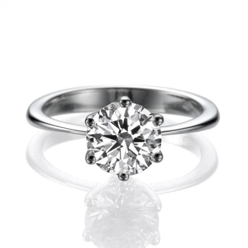 Amazing classic cathedral solitaire diamond engagement ring. Center stone is of 2 carat, natural, round, F-G color, VS2-SI1 clarity, GIA certified diamond, set in slick 14K White Gold 6-prong setting. The ring is meticulously hand made with great