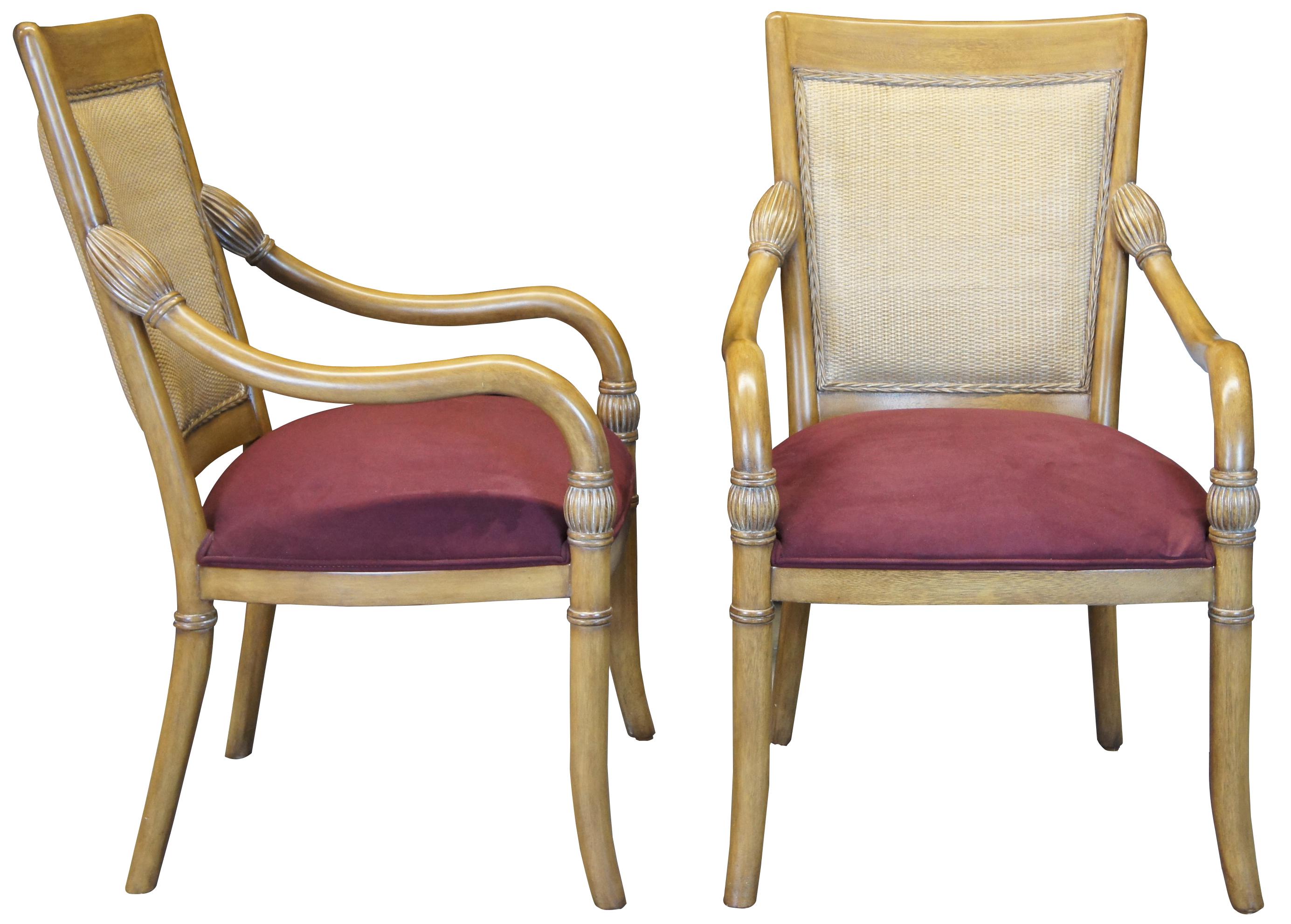 A beautiful pair of Kreiss Luxury Empire style arm chairs. Made from mahogany with a wicker inset backing and swooping arms with bulbous fluted turnings. Upholstered in maroon ultrasuede.
 