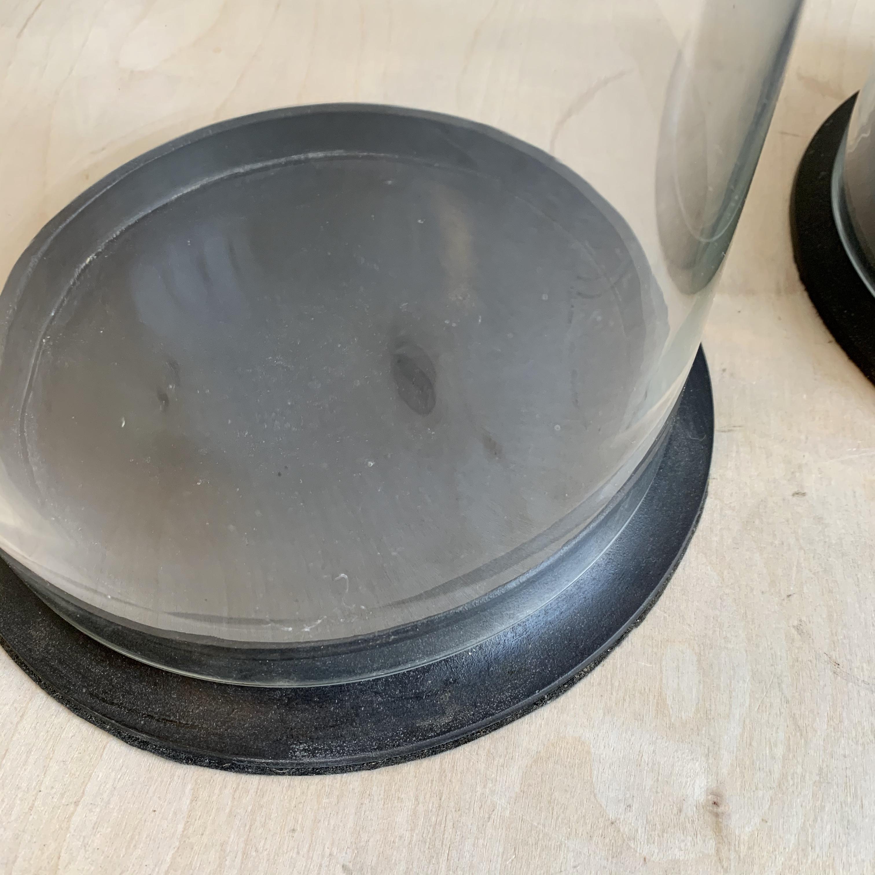 2 large glass domes on metal bases. Measures: 8