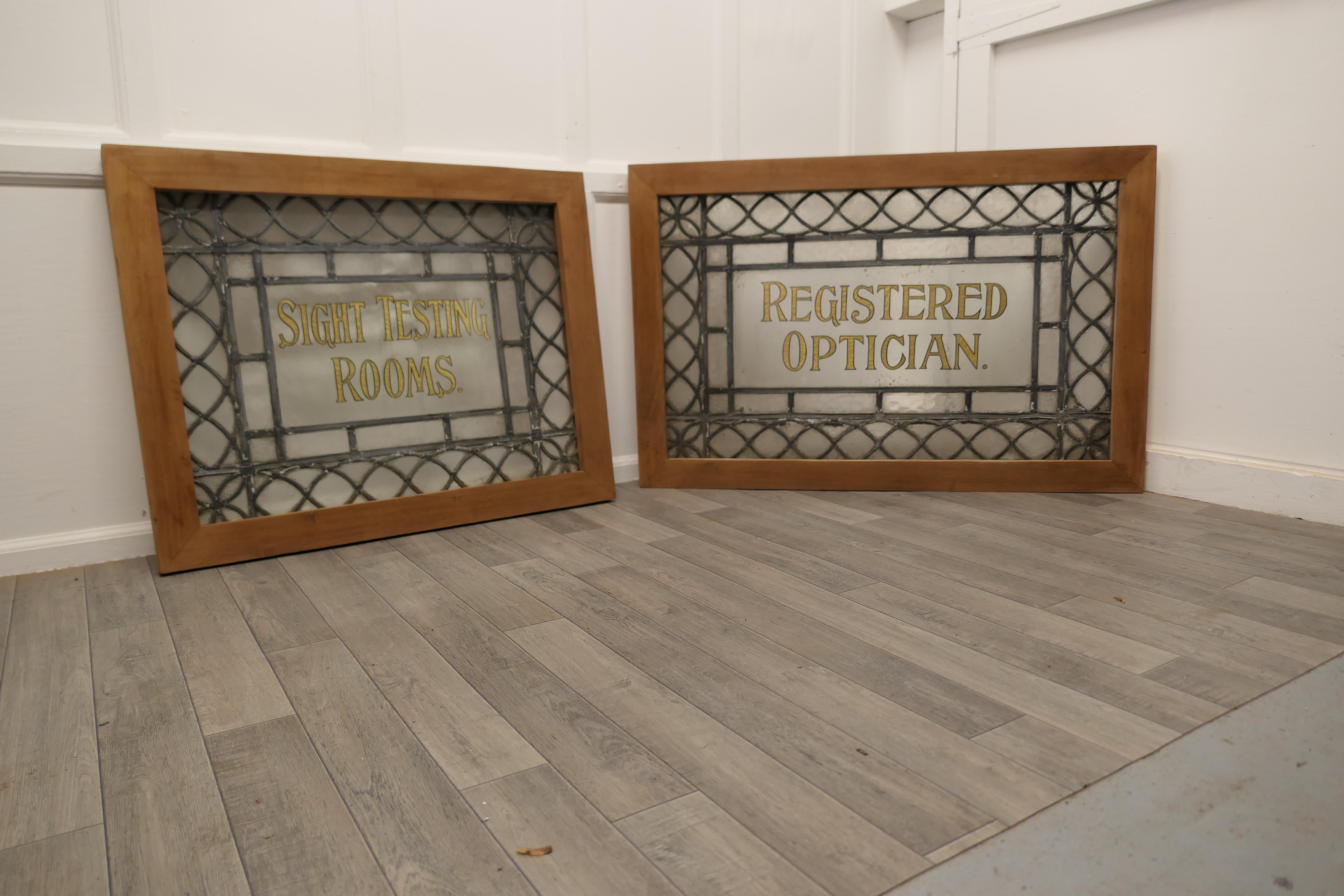 2 Large leaded glass optician’s window signs.

The window signs have both been mounted in a bespoke wooden frame, this is to allow them to be moved about, they lend them selves to being fitted into a new window.
The Centre of each sign has Gold