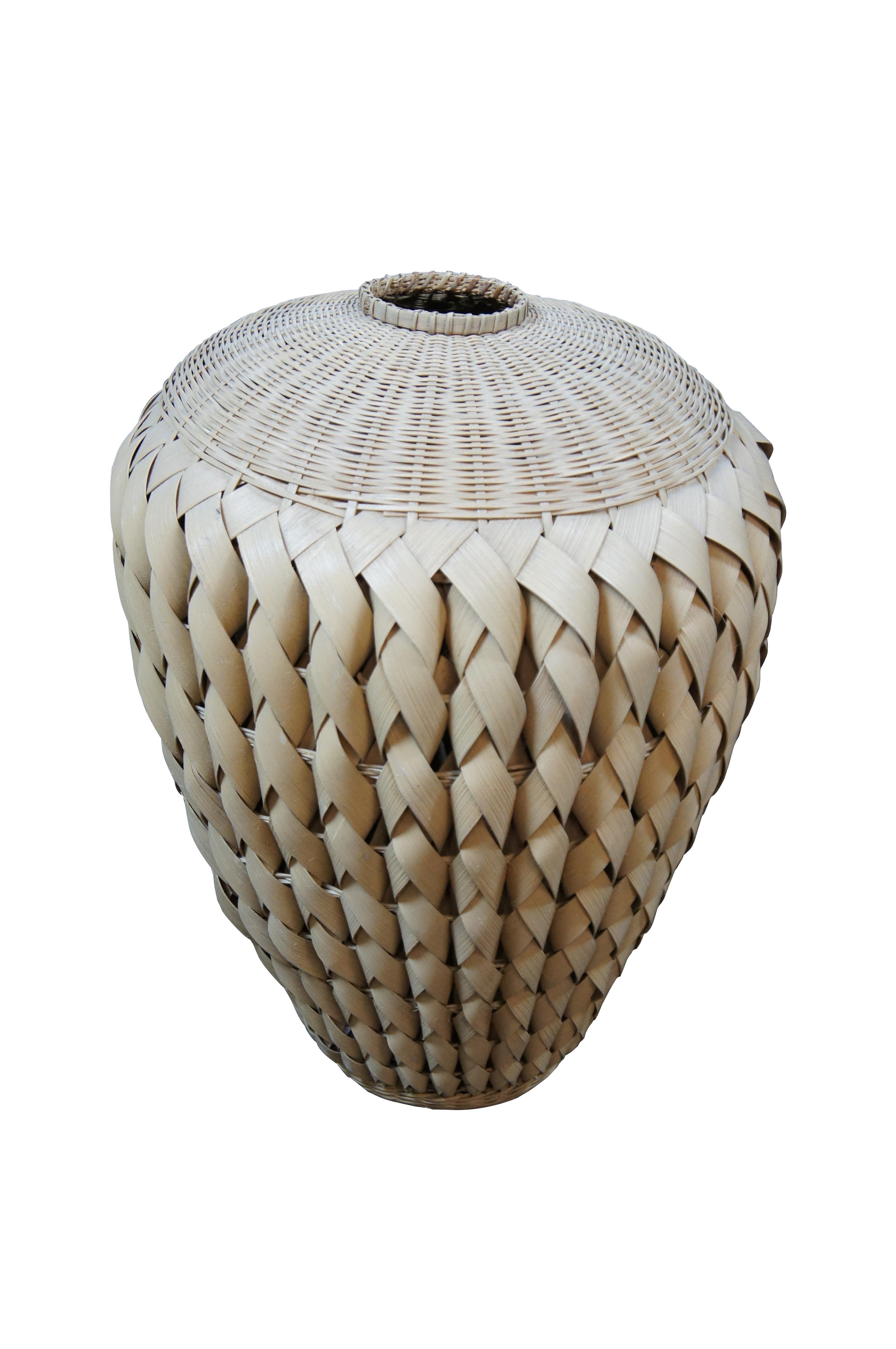 Pair of large vintage Bohemian woven palm / wicker floor vases / mantel urns. Round form with tapered base, beautiful braided design on the side with a dome shaped woven top and small mouth.

Dimensions:
16