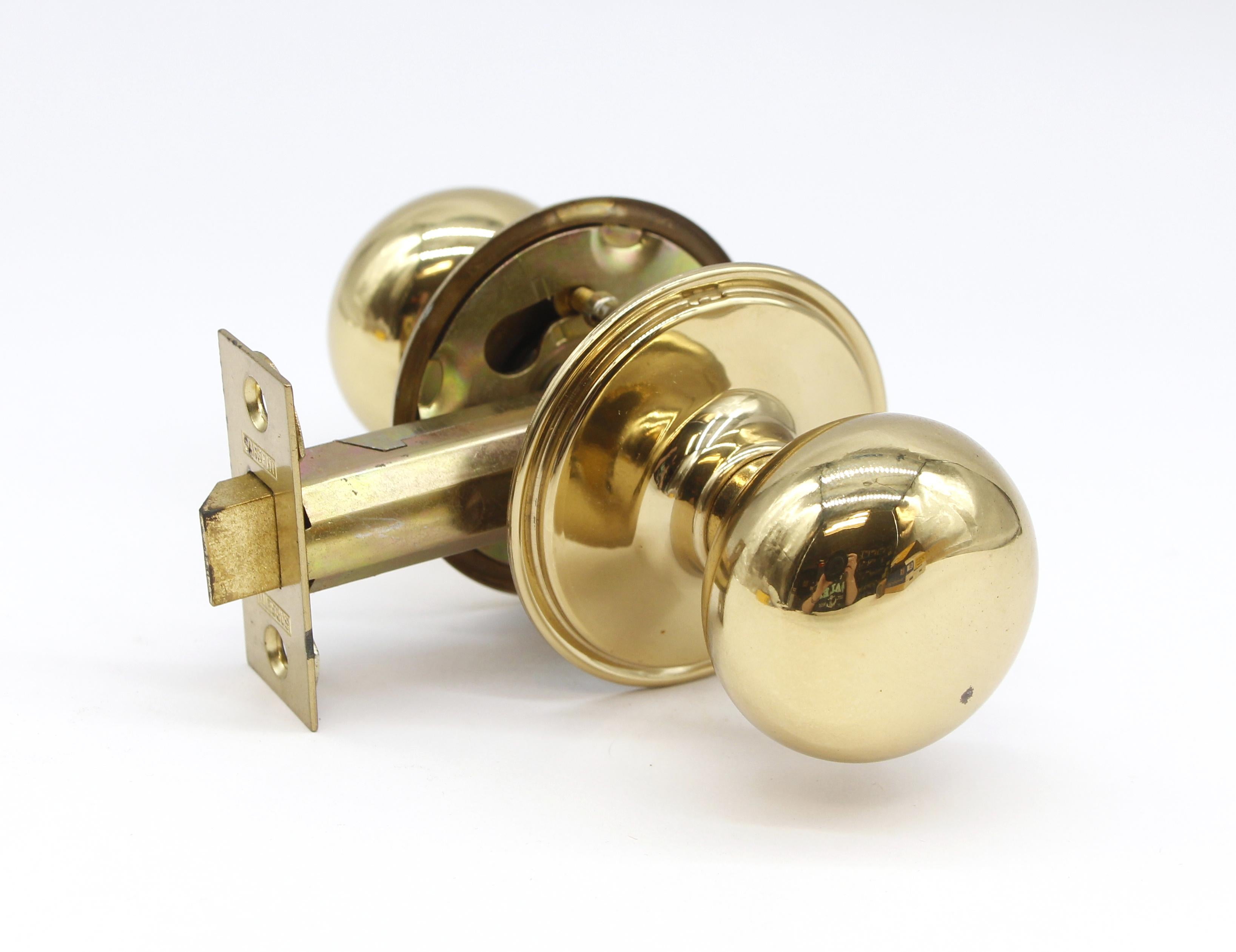 Mid-20th century new old stock polished finish brass passage door lock set manufactured by Sargent. 