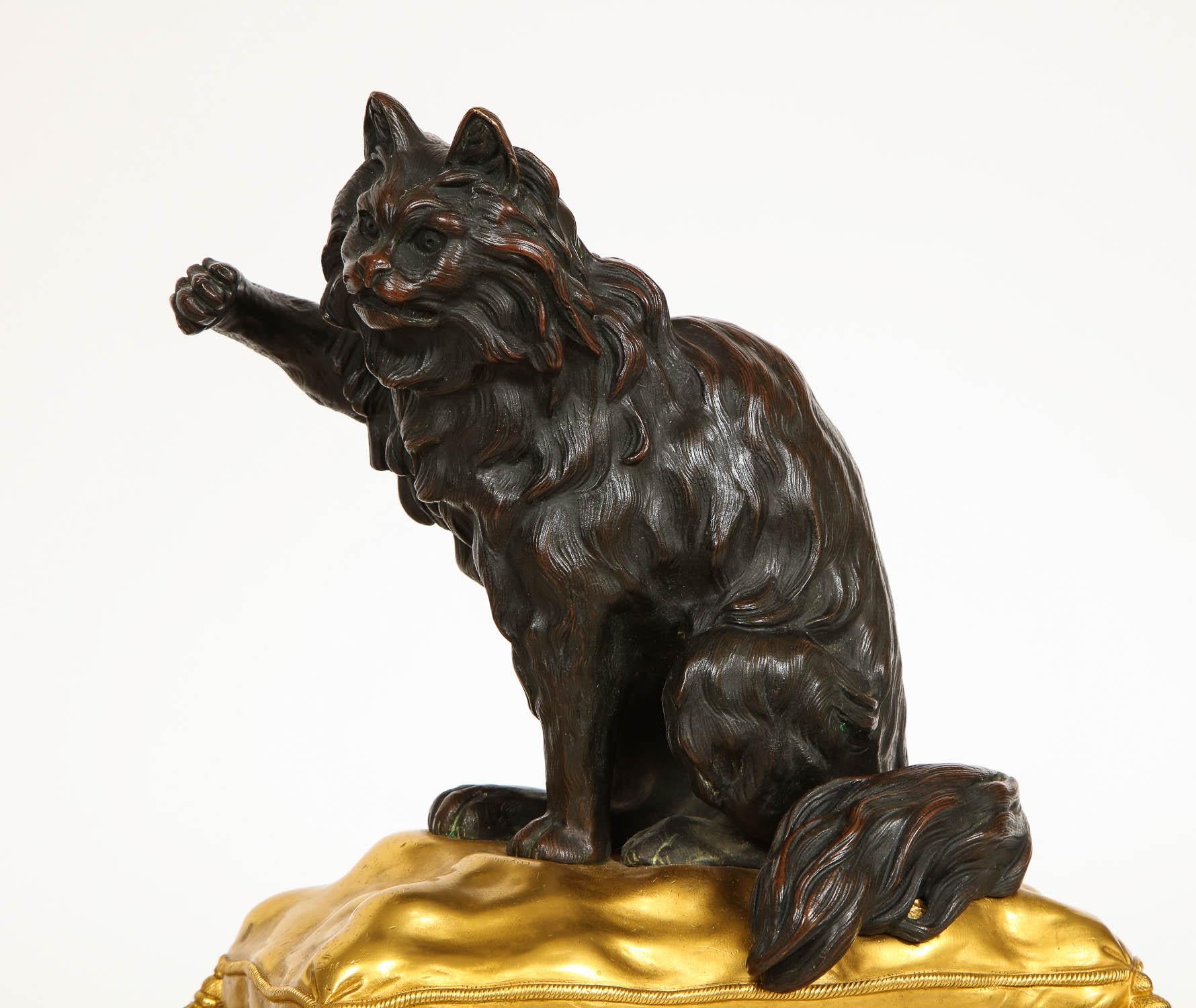 A Magnificent Pair of Large Antique 19th Century French Louis XVI Style Two-Tone Patinated and Dore Bronze Dog and Cat Form Chenets/Andirons Modeled after Jacques Caffieri (1678–1755).  This beautiful pair of ormolu and patinated bronze chenets