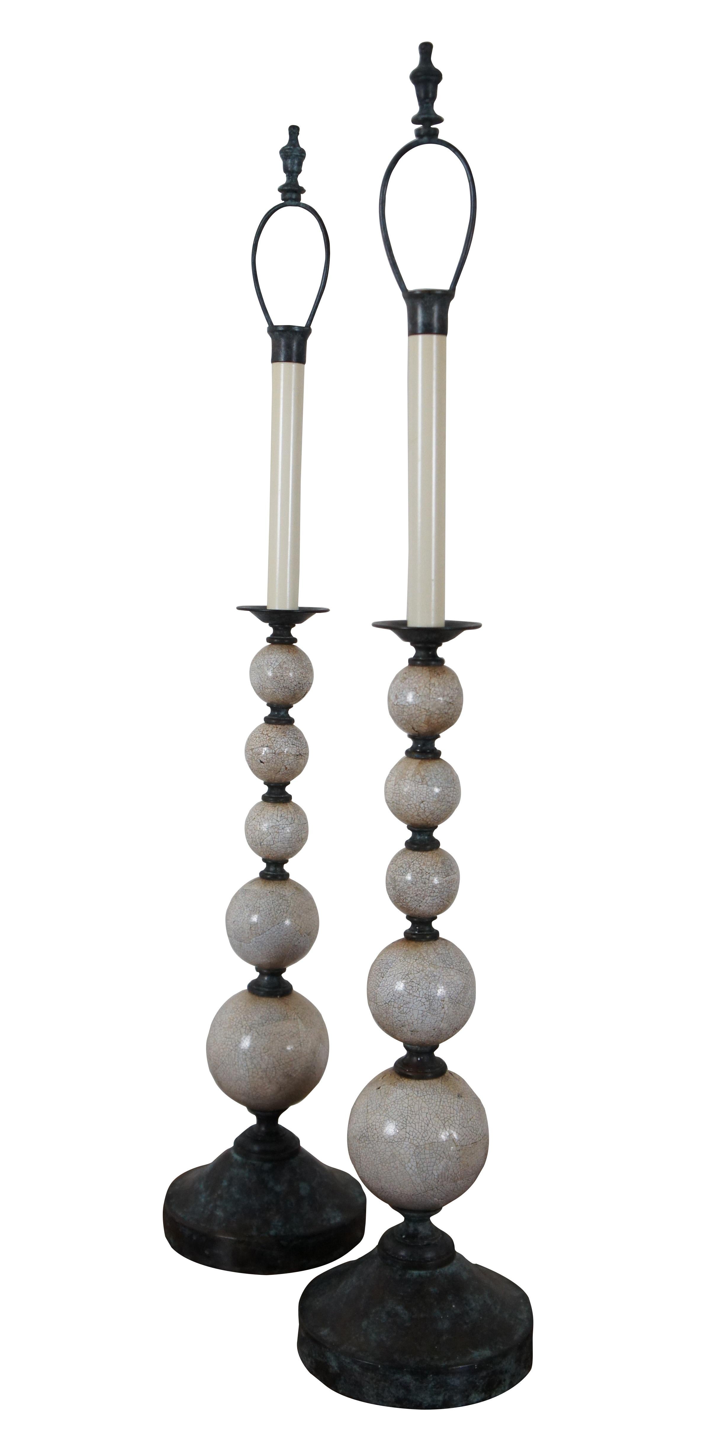 Pair of two Maitland Smith buffet / table lamps featuring round bronze bases and urn shaped finials with factory distressed patina / verdigris, with a series of five stacked white shell mosaic balls of graduated sizes supporting faux candlestick