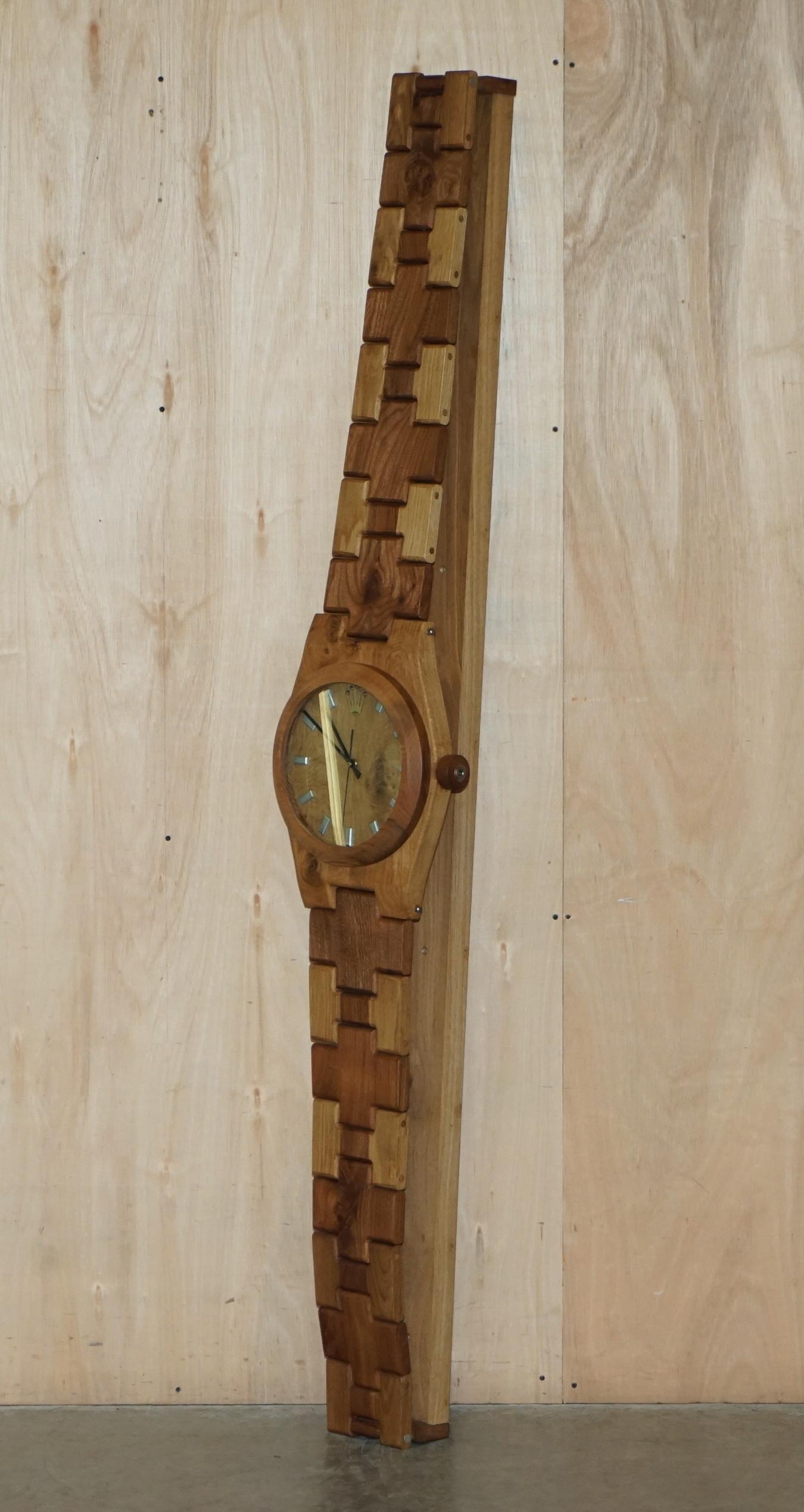 We are delighted to offer for sale this very unique hand carved English oak and elm Rolex Oyster Perpetual wristwatch 2 meter tall wall clock

This is a very rare chance to buy an original Rolex shop fitting display piece, hand carved in Elm and