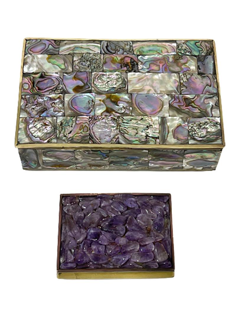 2 Mexican brass boxes, 1960s

Brass boxes with Abalone shell and Amethyst stones
2 Rectangular boxes with rosewood interior with hinged lid and 1 with square parts Abalone shell covered on top and side ways, marked with Mexico, raised on 4 round