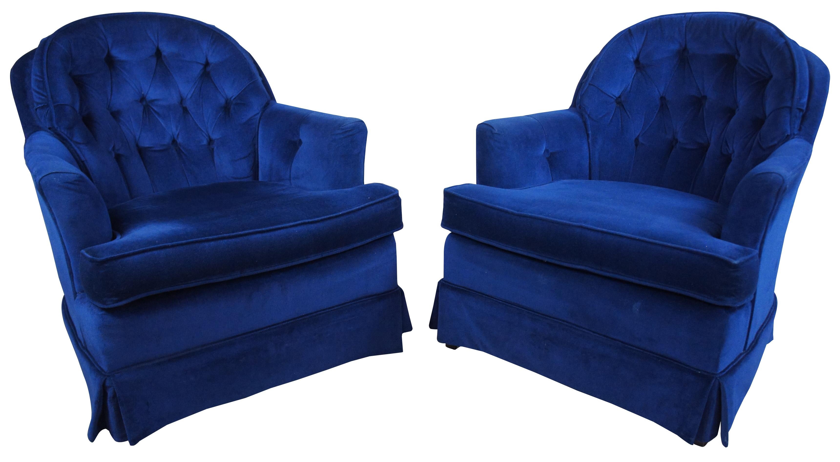 Two midcentury royal blue gentleman’s chairs. Features a tufted pillow back, supported by mahogany feet.
    