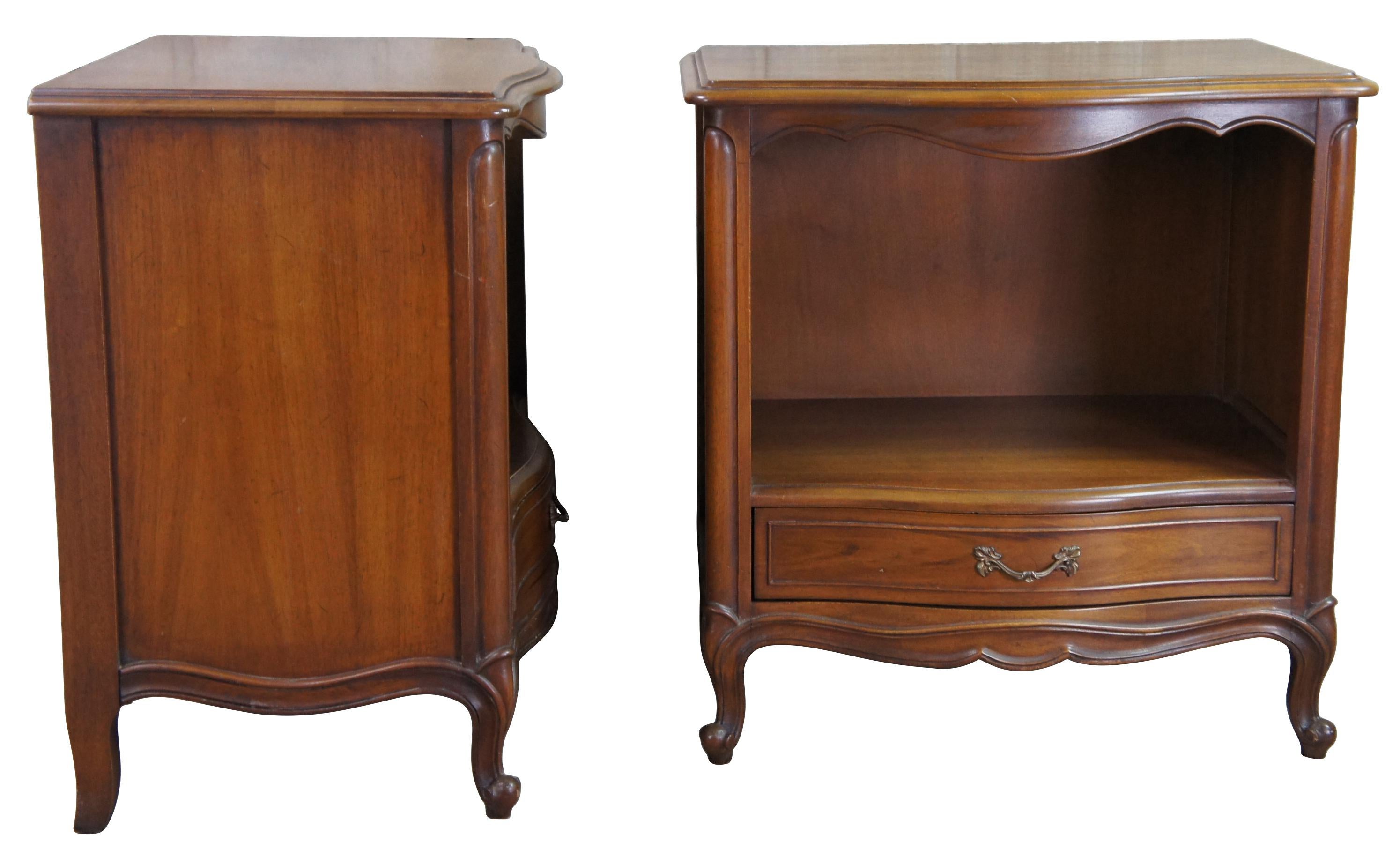 Mid century Drexel Bordeaux nightstands or side accent tables featuring serpentine form with one drawer and open cubby over cabriole legs. Circa 1966-1728.
 