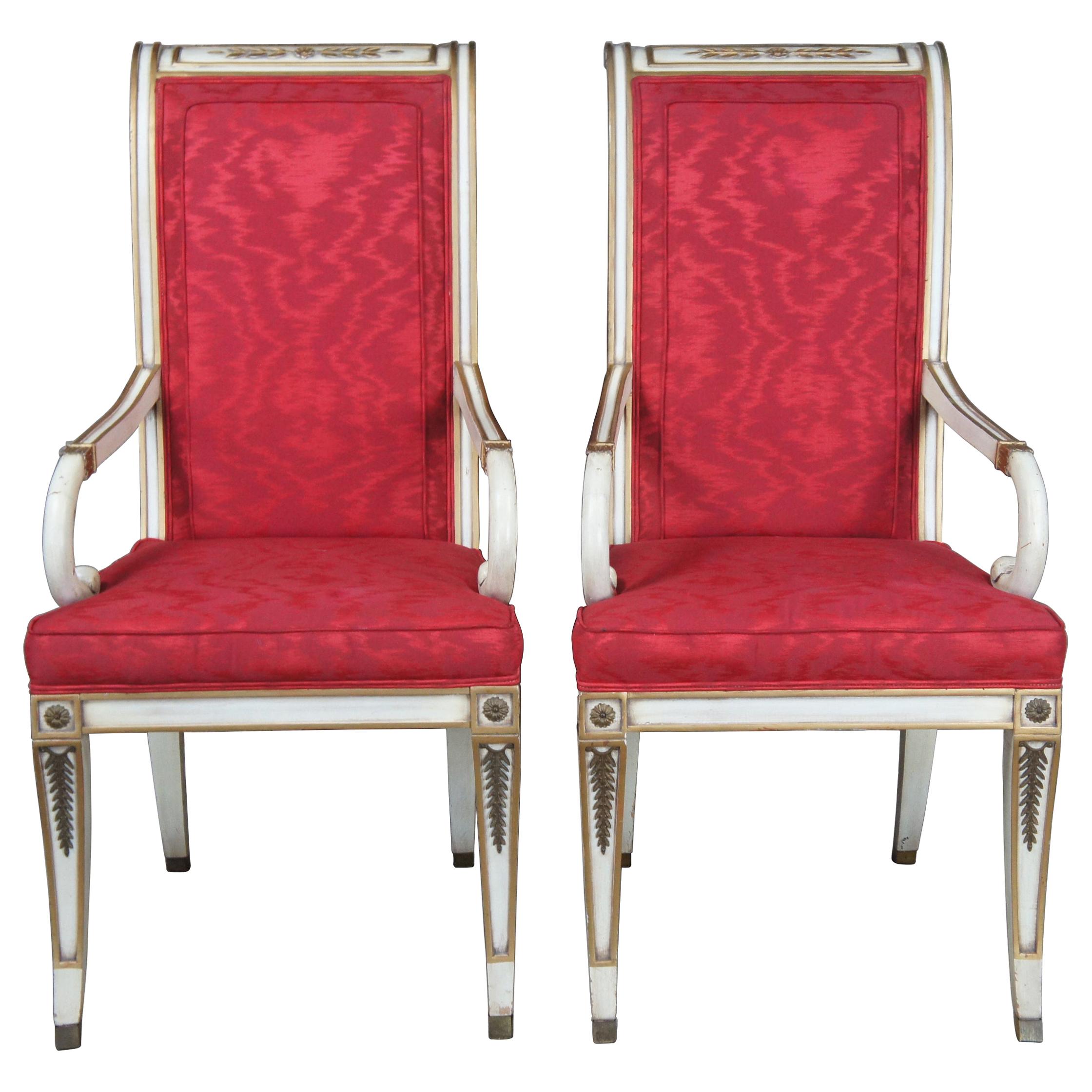 Two vintage Karges French Empire dining arm or accent chairs. Painted white with gold carved accents, scrolled arms, brass plates, saber legs and red upholstery.

Karges carefully crafts exquisite masterpieces in their Grand Rapids, Michigan