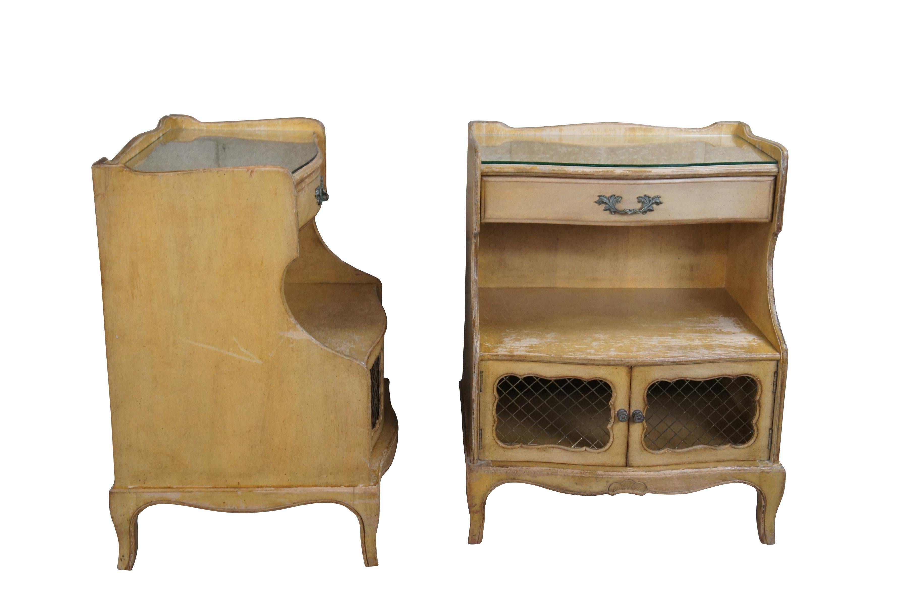 Two mid century French Provincial nightstands featuring lattice door cabinet, two tiers, drawers and upper gallery.  Includes glass top.  Attributed to Bethlehem Furniture Co.  A great candidate for refinishing or painting.

Dimensions:
19.5