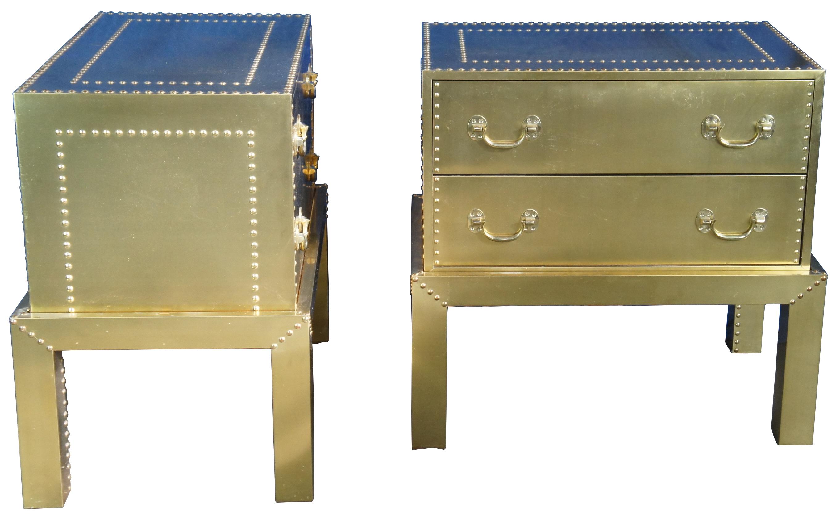 Pair of mid century Spanish chests of drawers on stand, nightstands or side tables. Wrapped in brass featuring nailhead trim. Marked Espana, A Decorative Craft, Hand Made in Spain, 3910. Attributed to Sarreid Ltd. circa 1970s

Provenance : Jerome